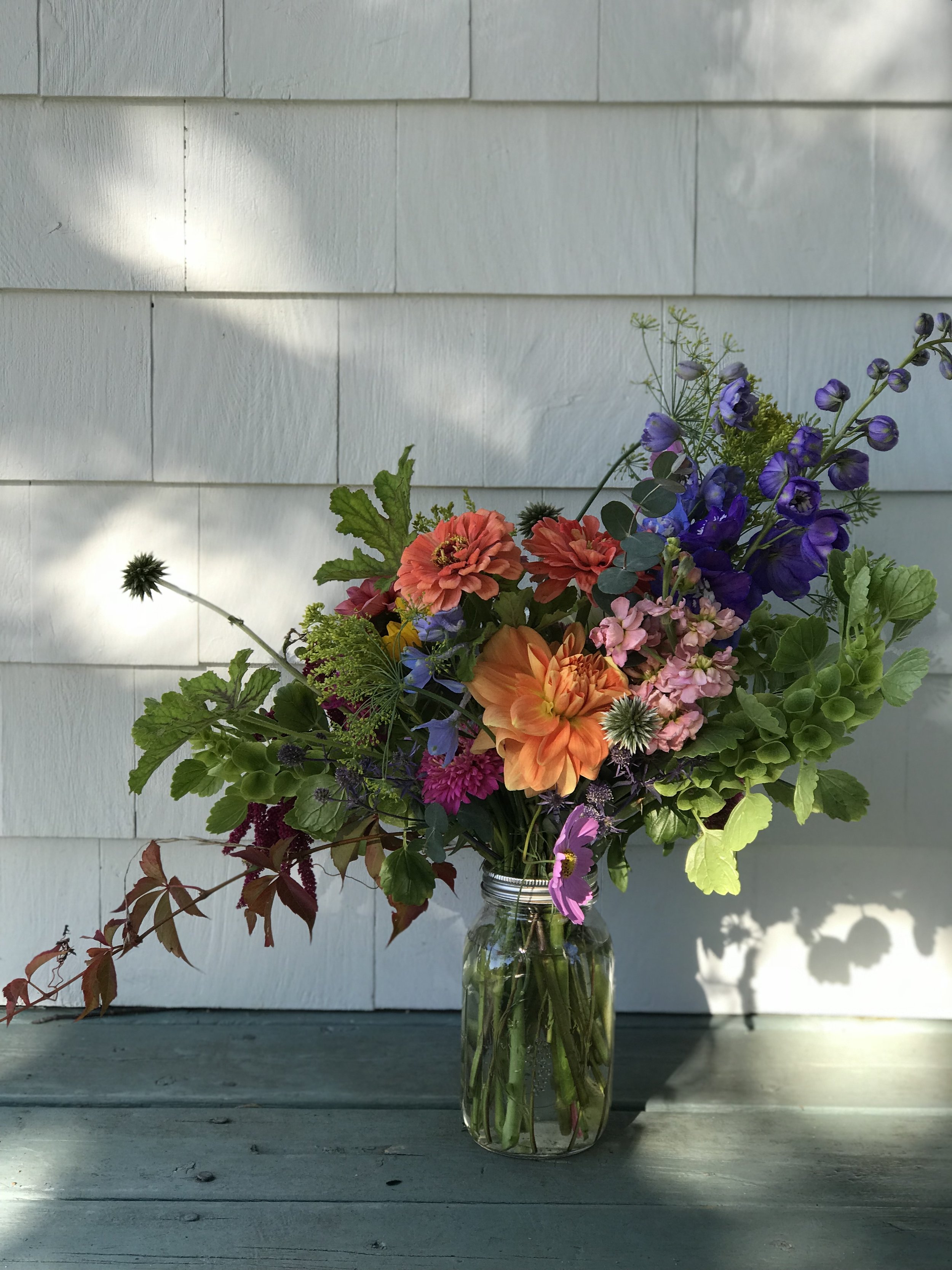 vase arrangement in orange and purple