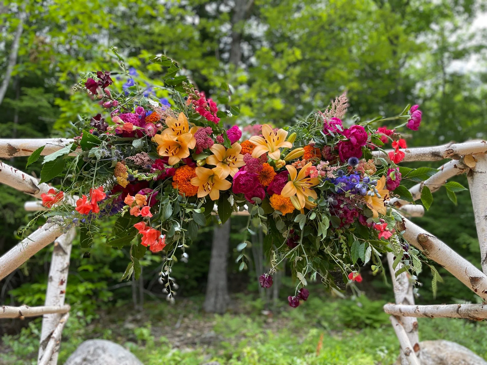 orange lilies in floral arbor at Garden Gate 