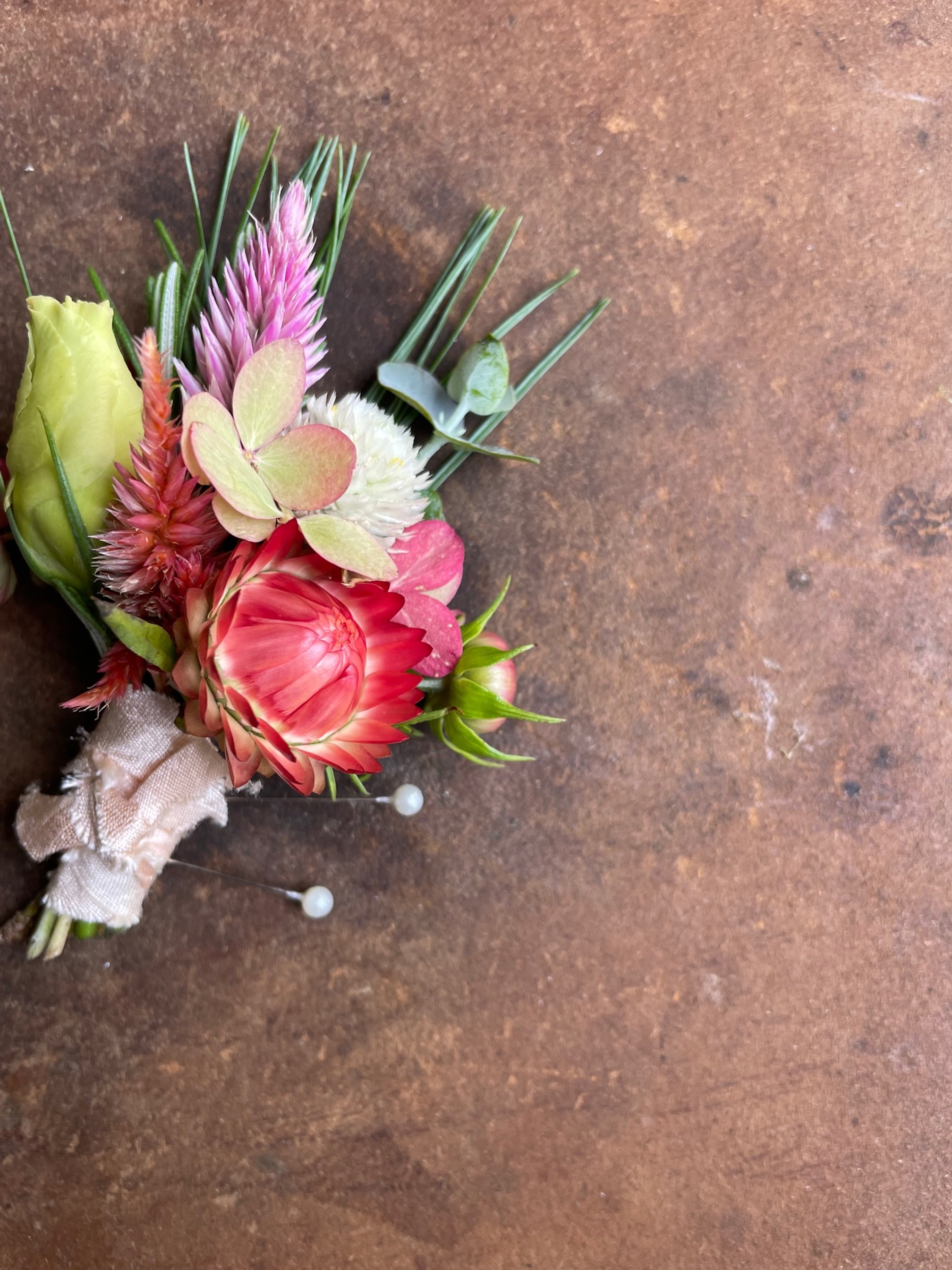 boutonniere featuring pine and fall tones