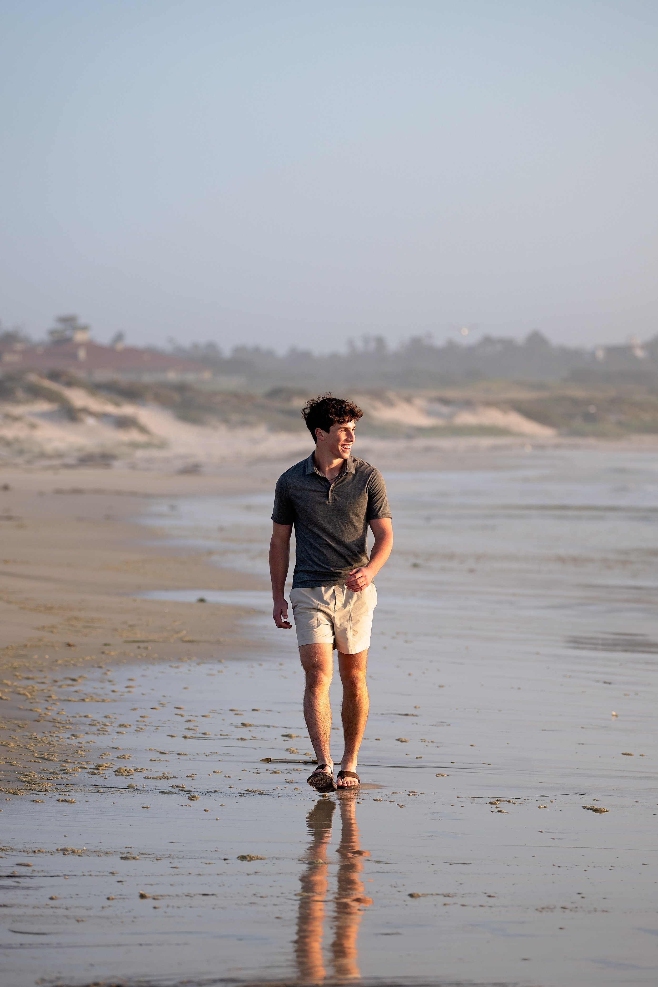Boys senior portraits walking along the beach in Monterey