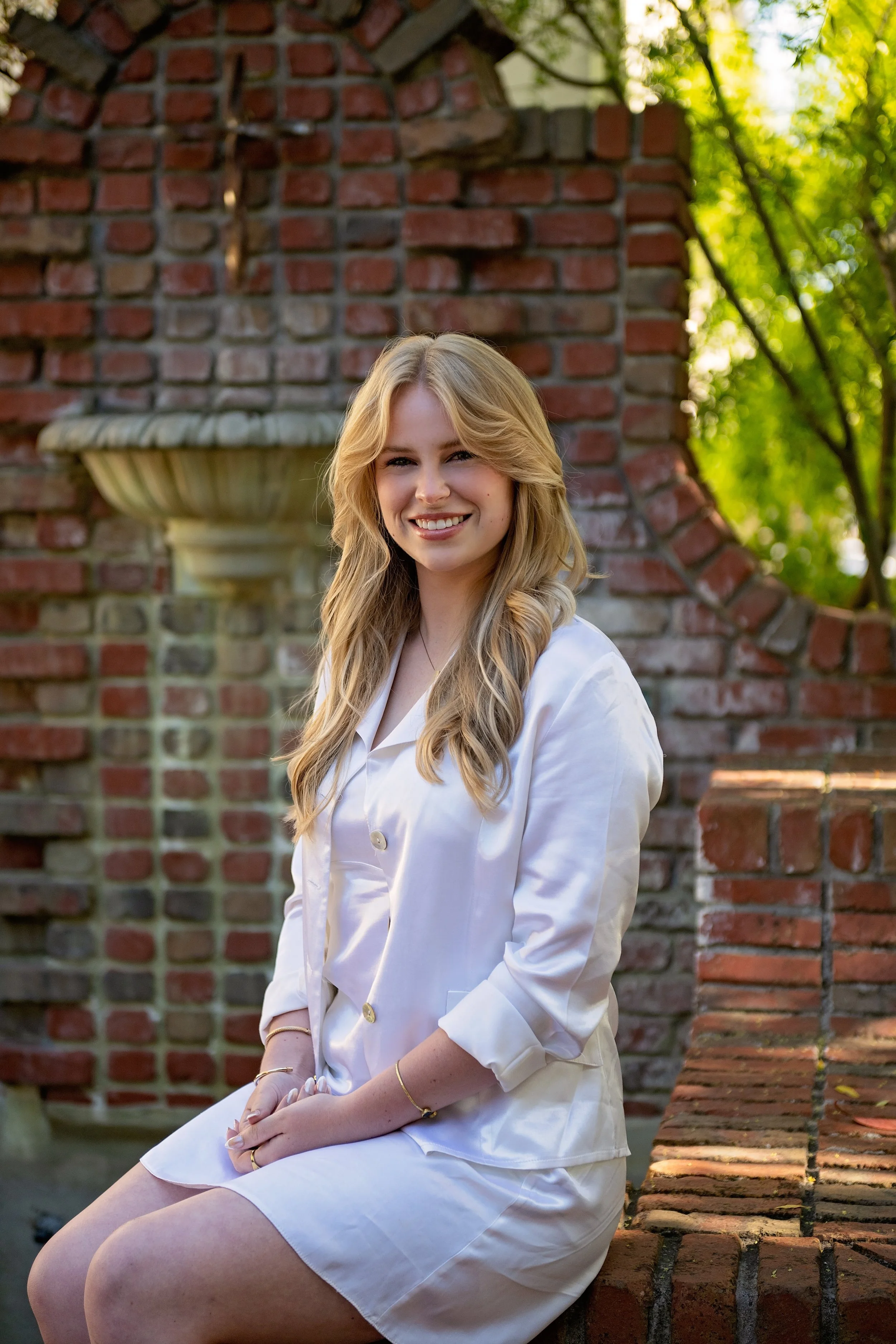 Camden posing along the brick garden pathways during her senior pictures in Carmel-by-the-Sea