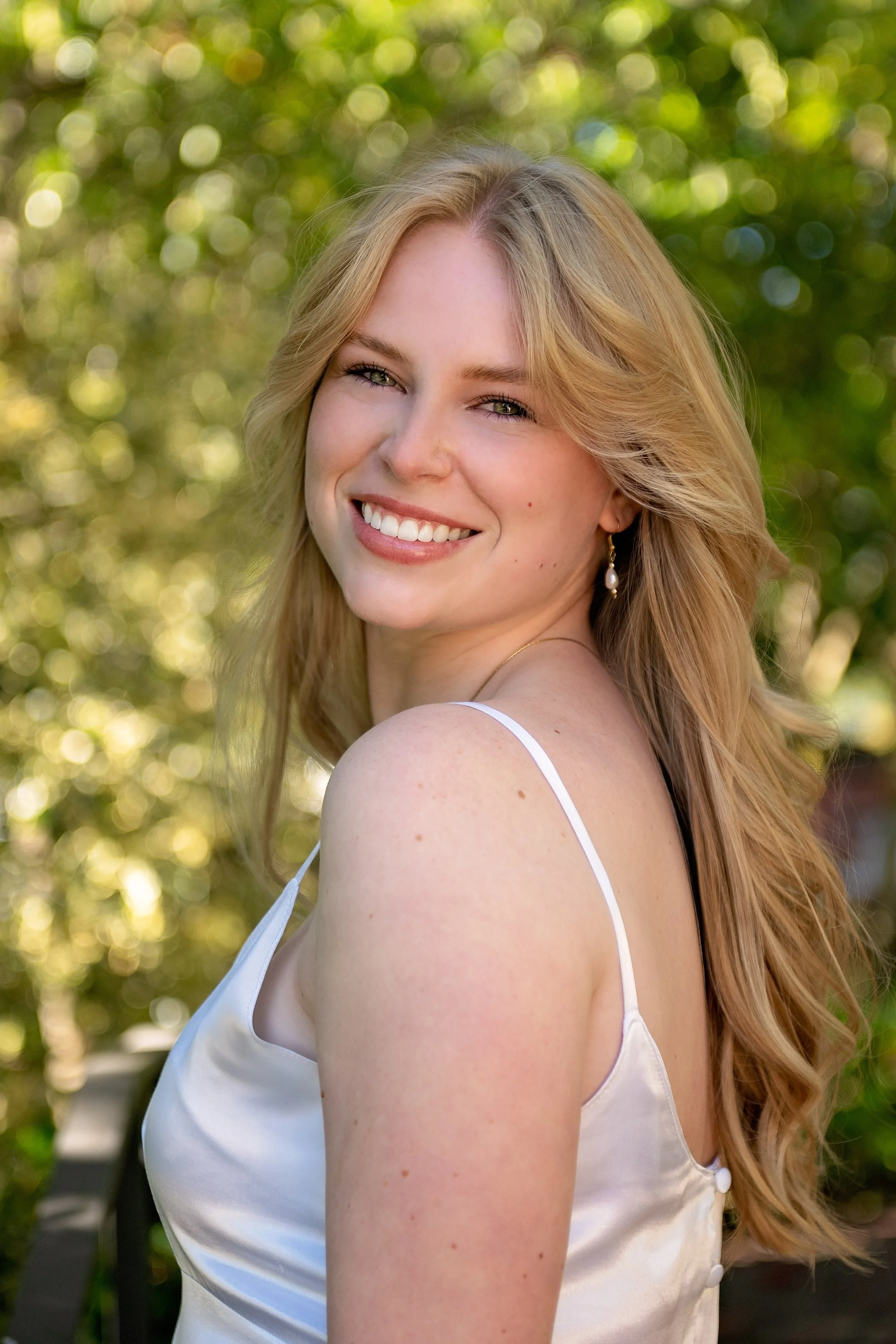 Camden photographed in a vintage white dress surrounded by the gardens of Carmel-by-the-Sea