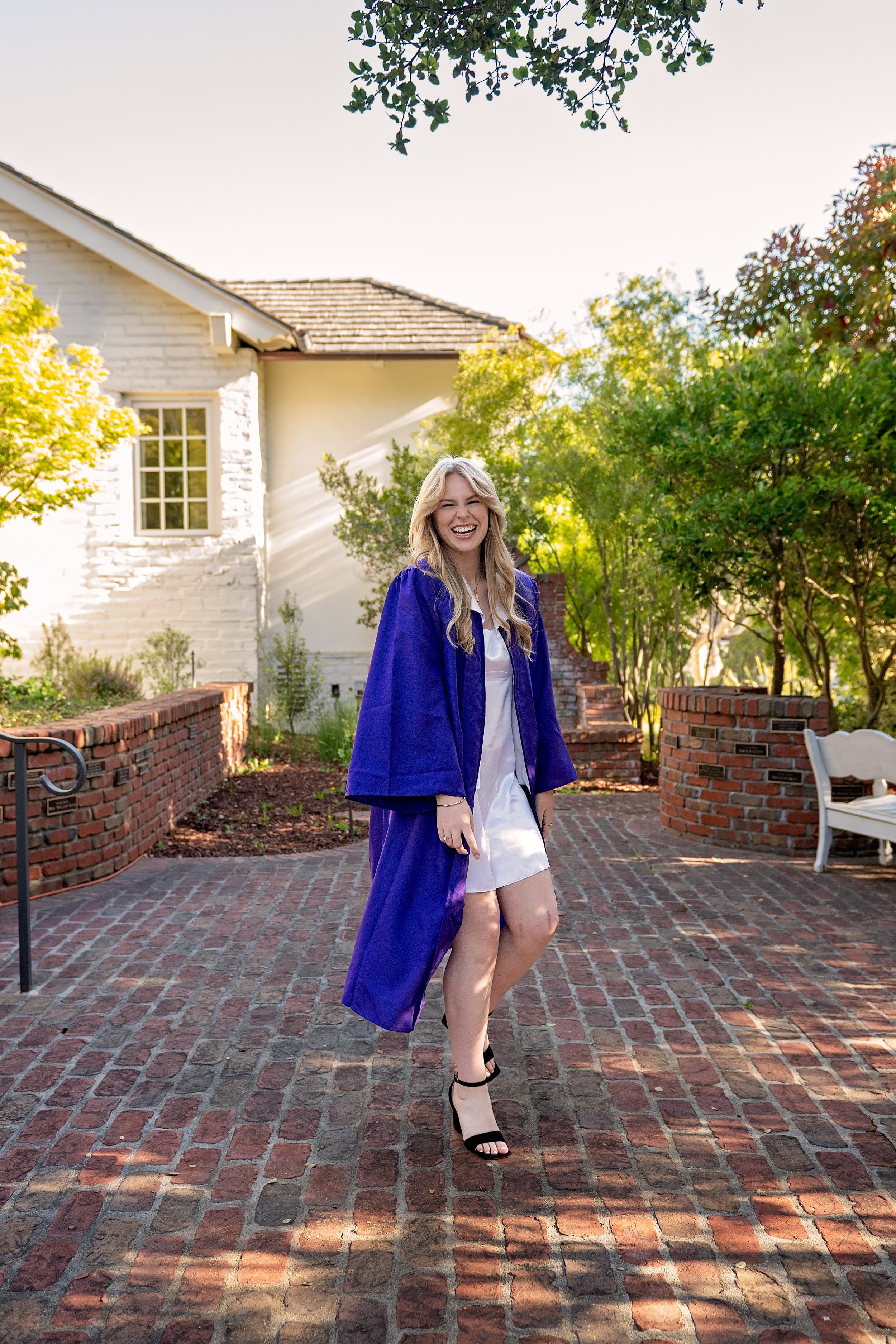 Salinas High School graduate Camden wearing her purple graduation gown for portraits in Carmel