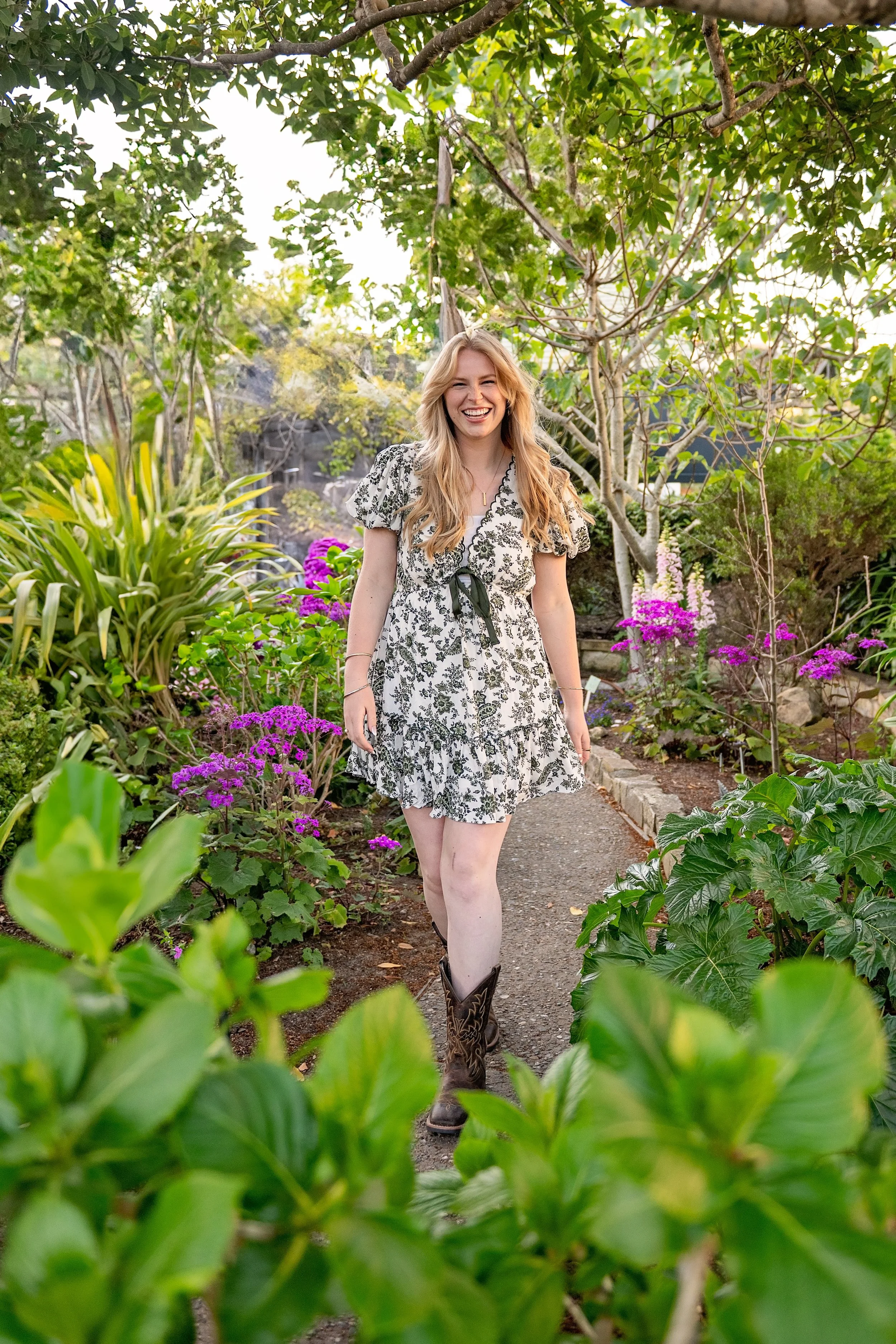 Camden walking through a colorful Carmel garden during her Salinas High School senior portrait session