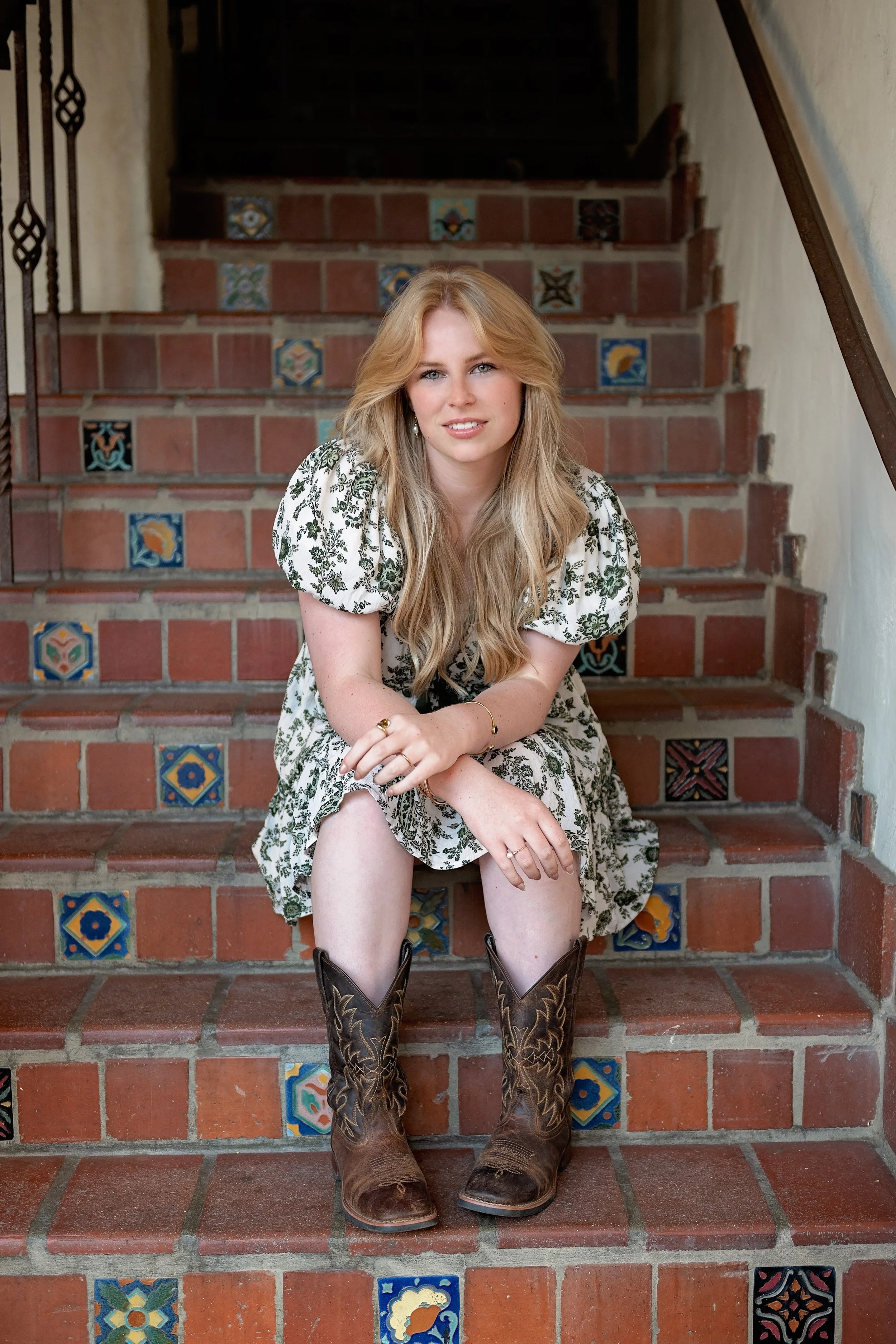Camden posing beside rustic Carmel architecture during her downtown Carmel senior photography session