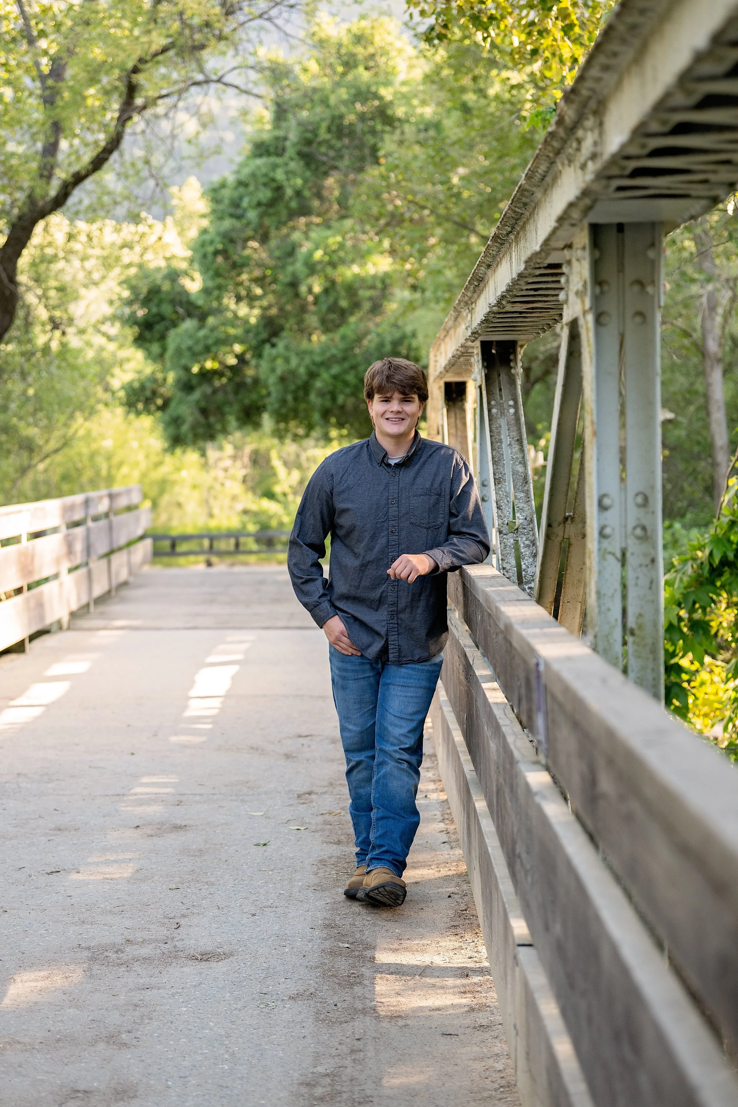 Senior portrait of Gianni leaning against the bridge at Garland Ranch in Carmel Valley.