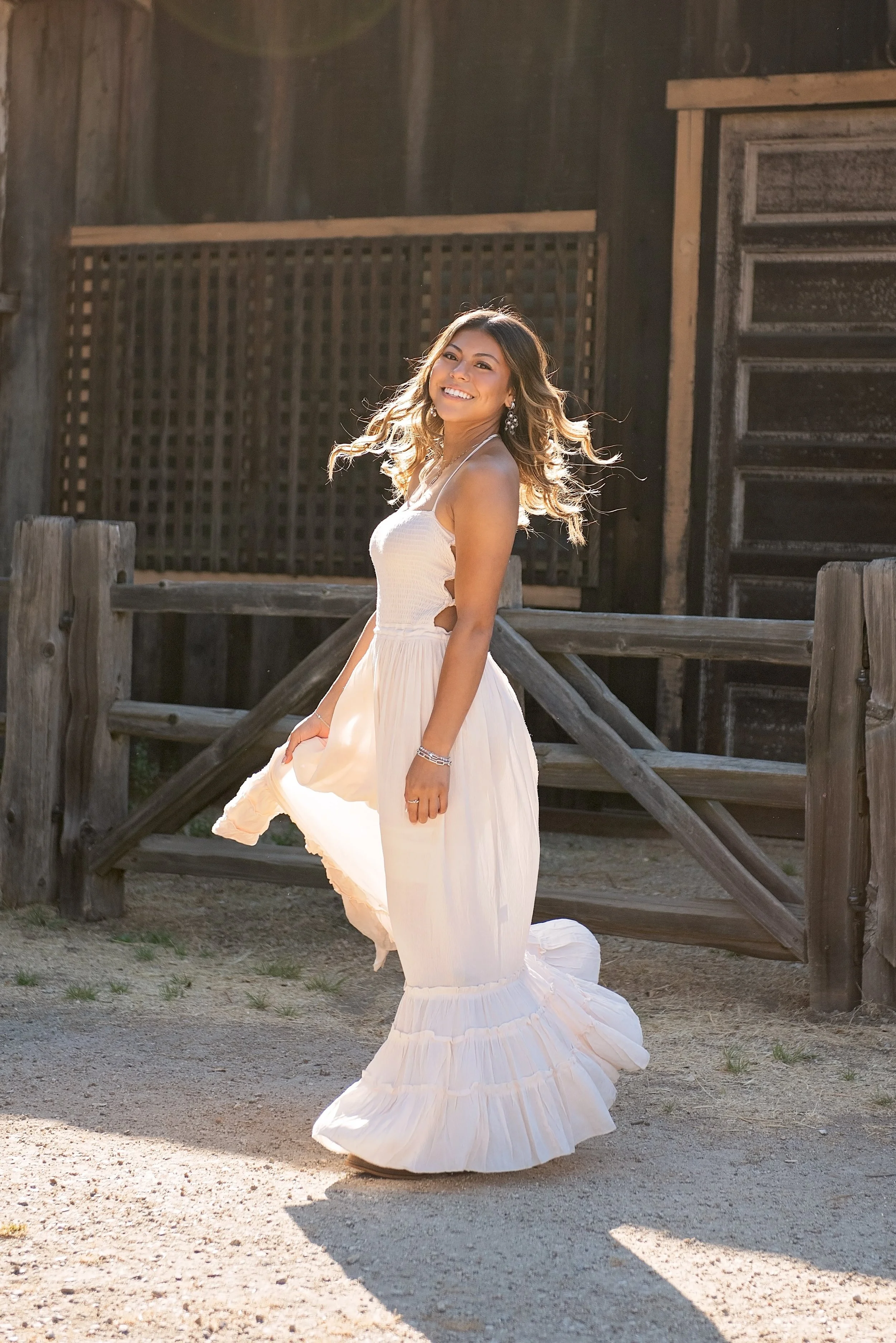 Aubrey smiling in a flowing white dress during her Carmel Valley senior portrait session at Garland Ranch