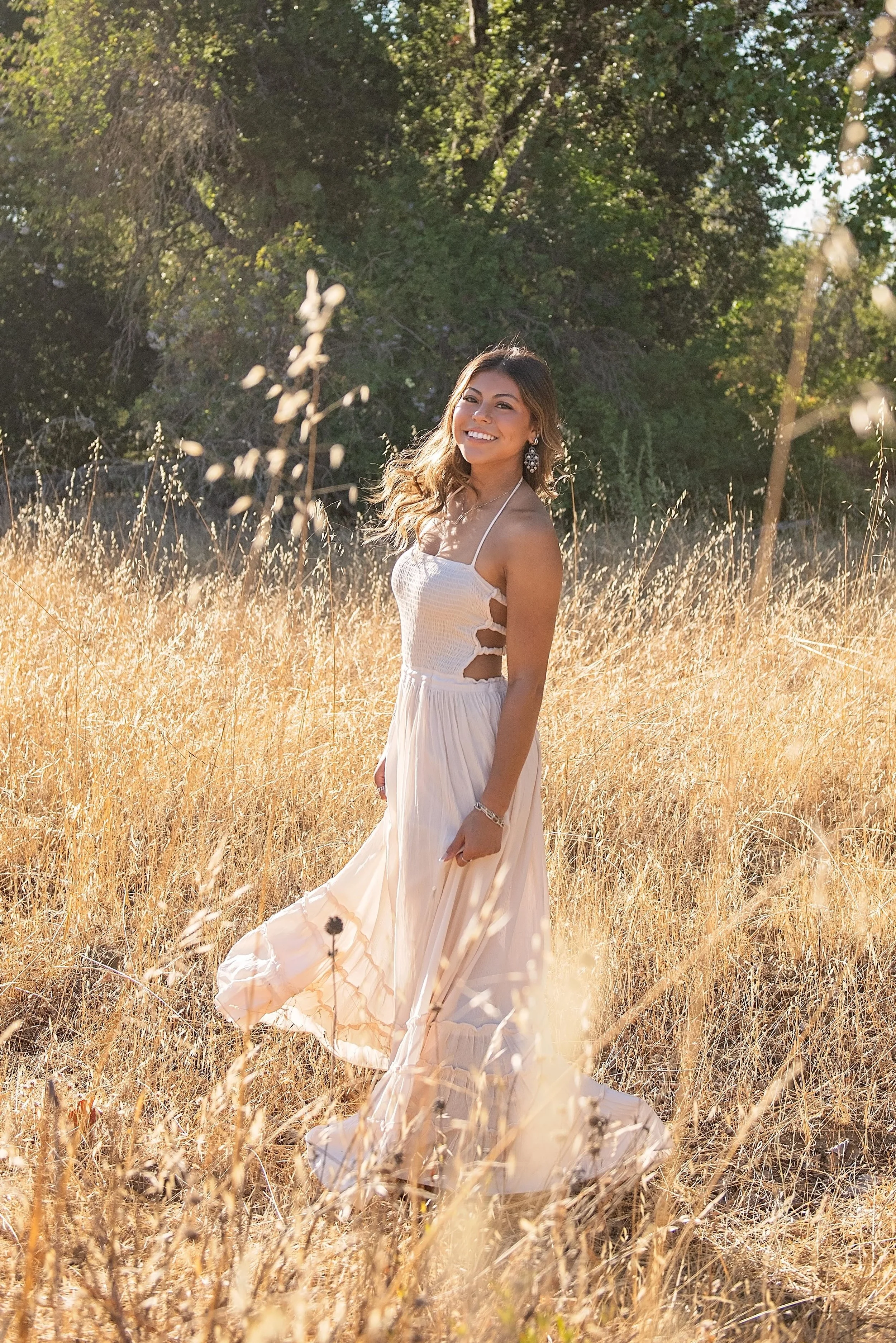 Aubrey standing in golden grass during her Carmel Valley senior photography session at Garland Ranch