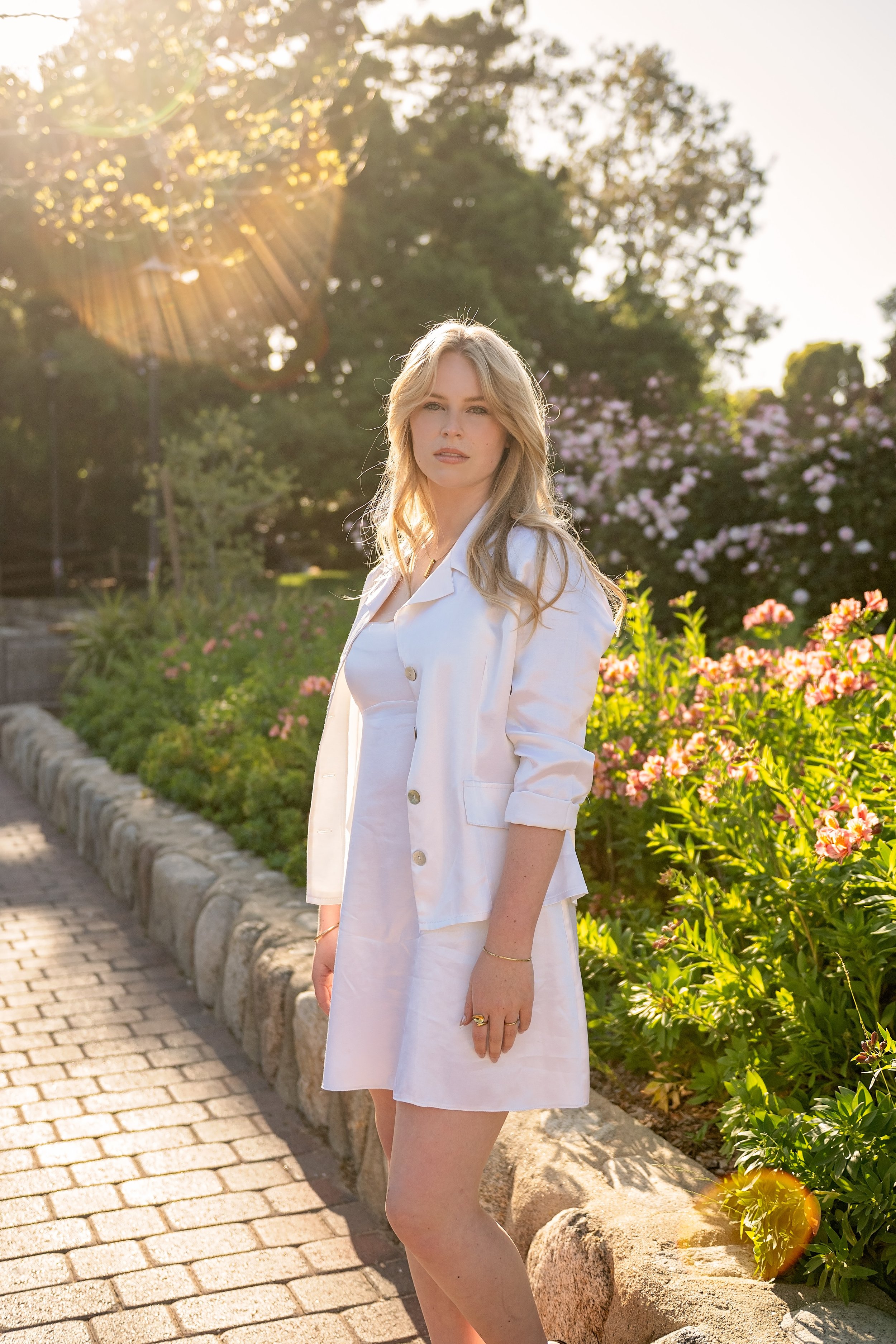 Camden photographed in warm golden light and flowers during her Carmel senior portrait session