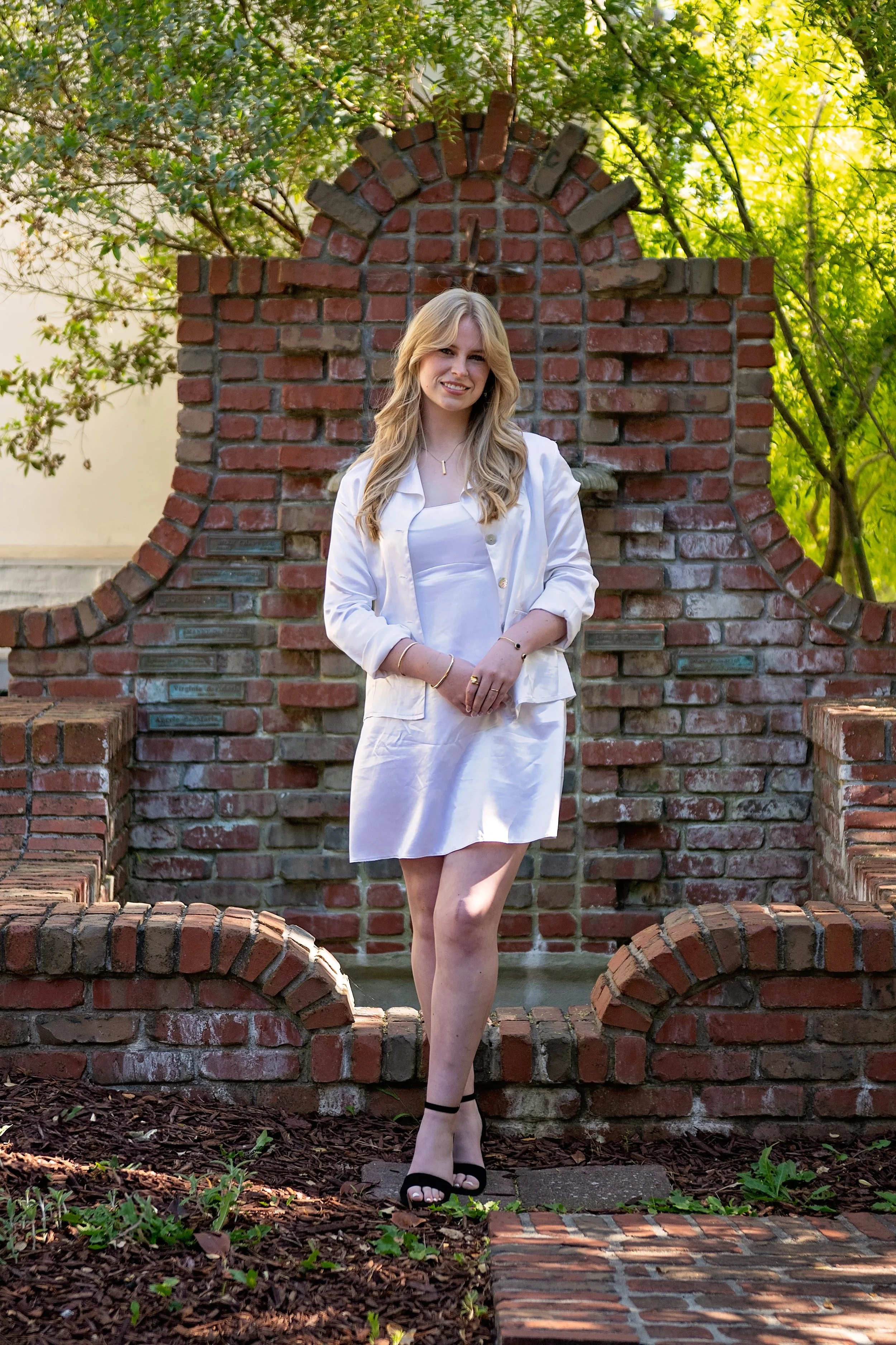 Camden, a Salinas High School graduate, wearing a vintage white dress for senior portraits in Carmel-by-the-Sea
