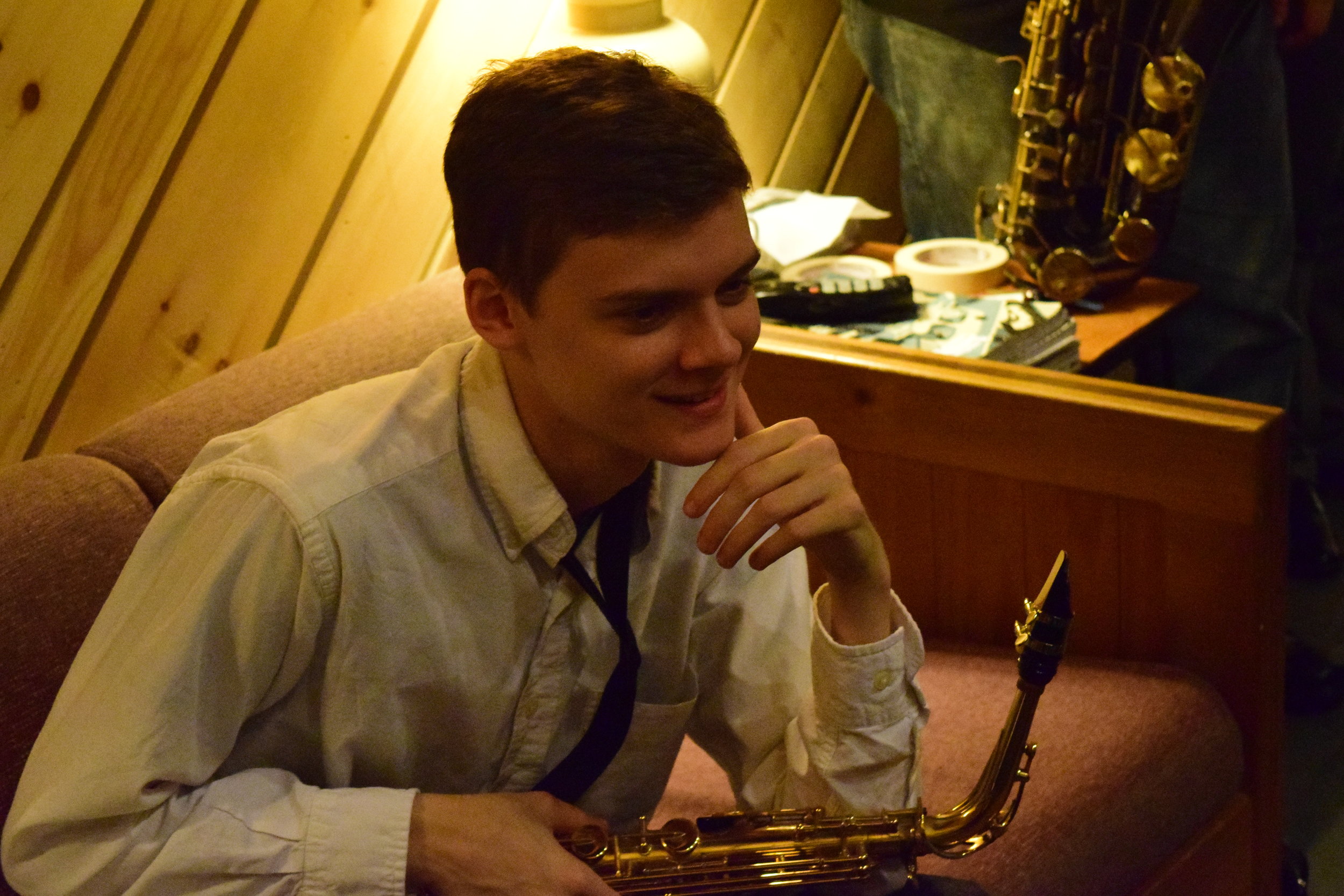 A Daniel Dickinson (not me) on a couch and holding a saxophone. A much more musical person with the same name!