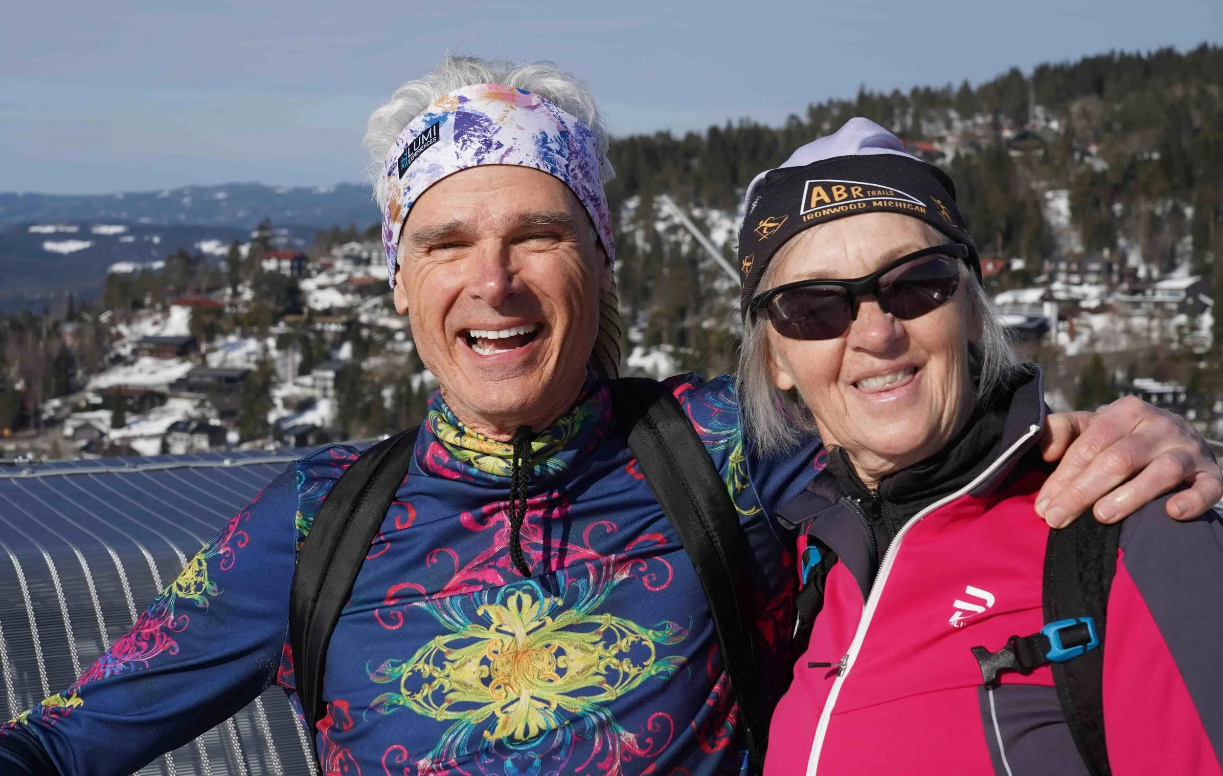 Cowboybob and his spouse Kathy smiling on a snowy trail while enjoying the bright late-winter sunshine in Norway.