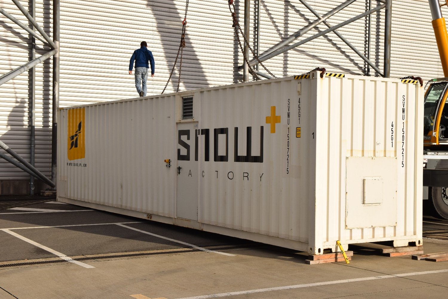 Snowmaking container set up outside a hanger at the Dresden Airport.