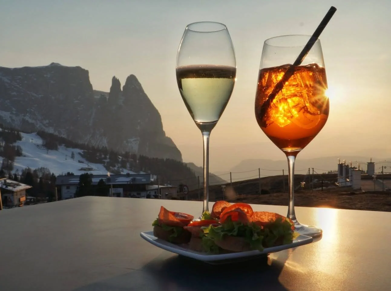  Enjoy an Aperol Spritz from the balcony of your hotel on Seiser Alm, with the sunset in the distance 
