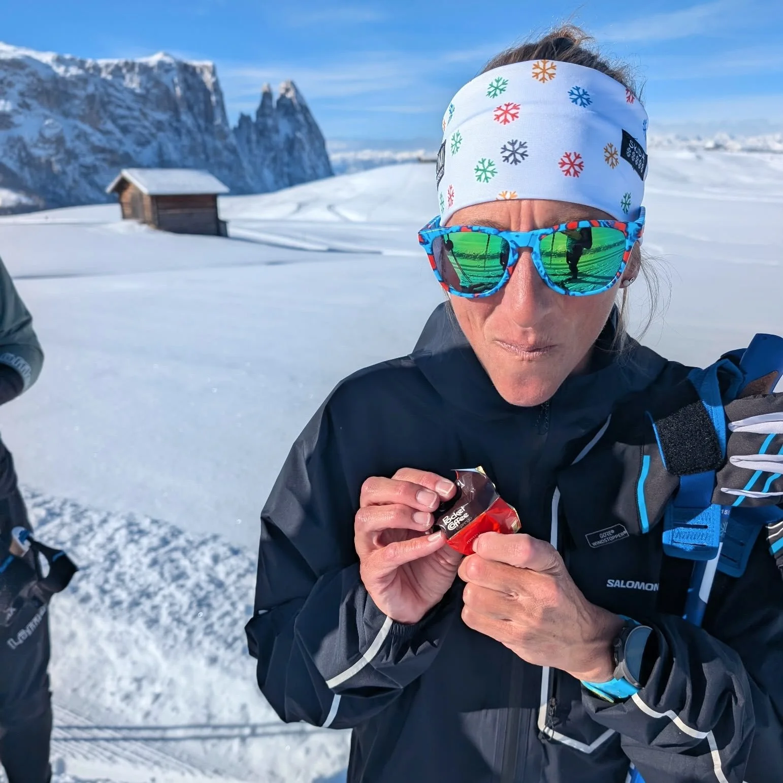Ultra-runner Courtney Dauwalter enjoying an Italian Pocket Coffee chocolate on sunny Seiser Alm