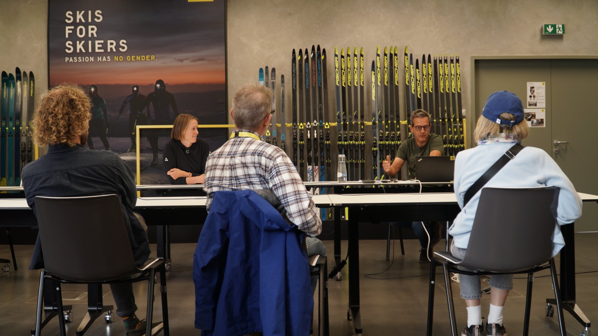 “Visitors touring the Fischer ski factory in Ried, Austria, observing ski production and manufacturing processes