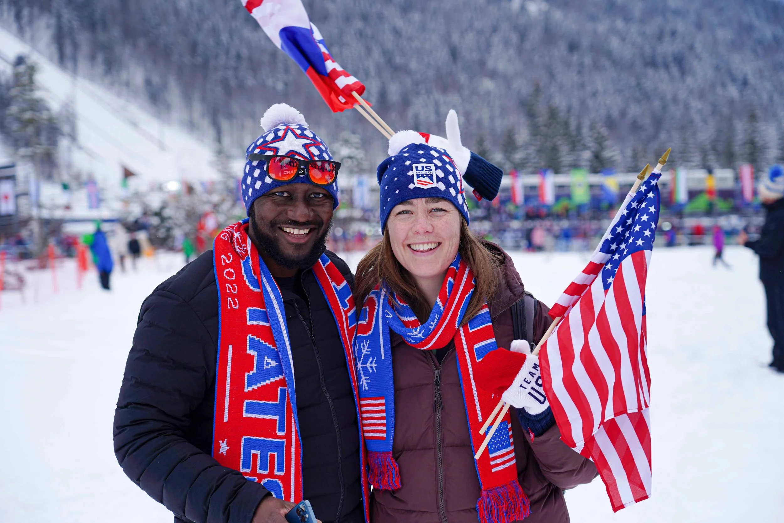 Trip Leader Oumar and his wife Rita wearing Team USA apparel at the 2023 Planica Nordic World Ski Championships