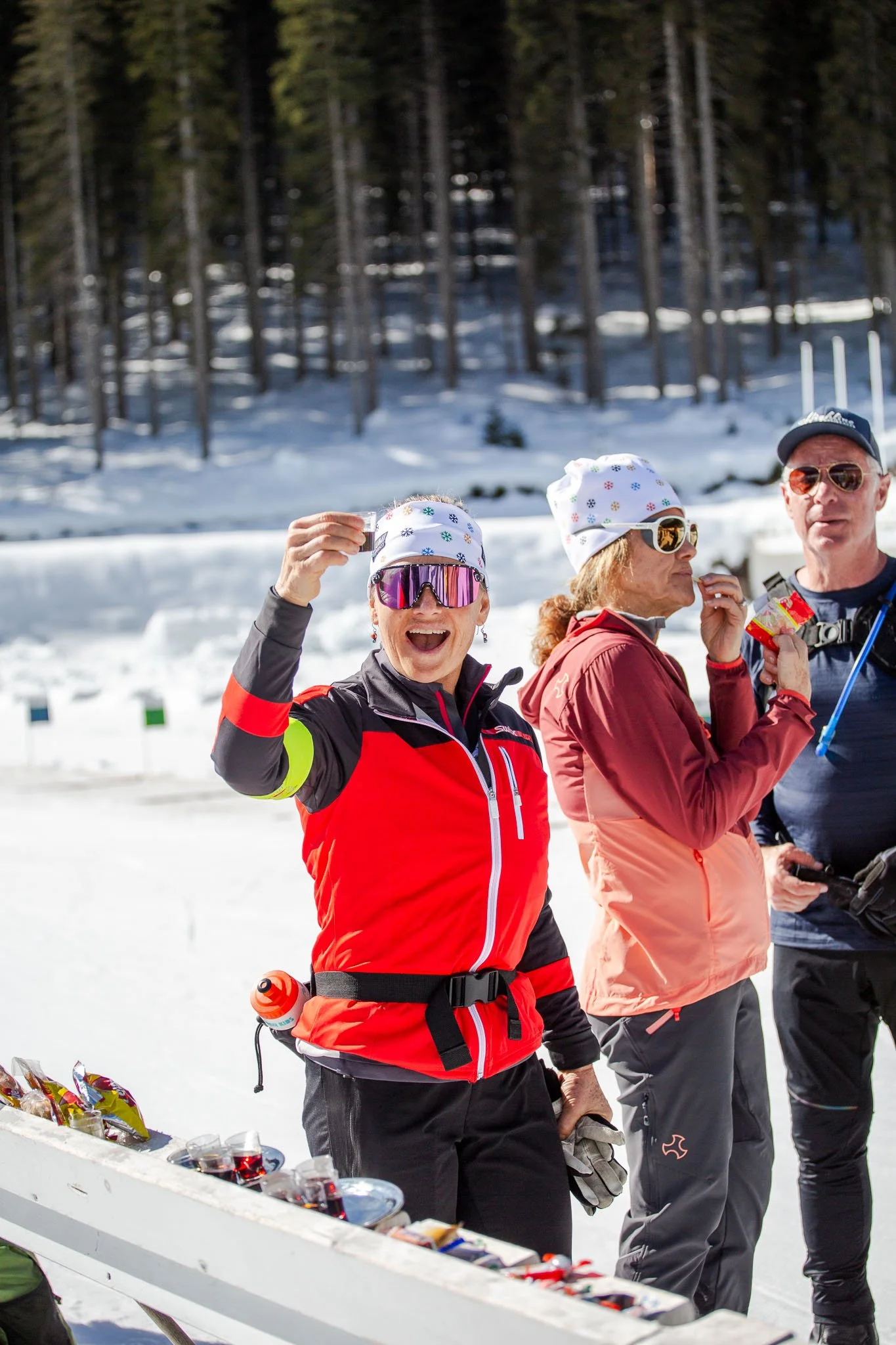 Participants gathering for drinks and toast after a biathlon session