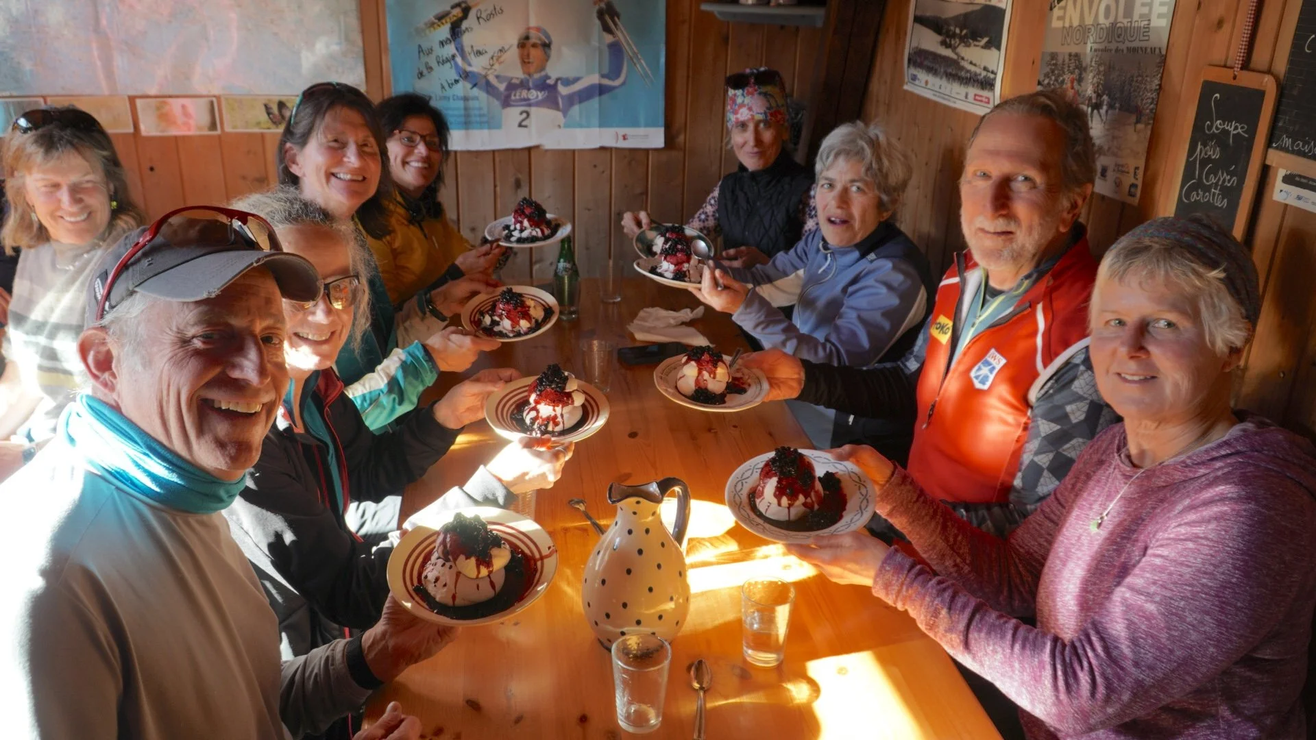 Group dining at a trailside hut with traditional food and dessert