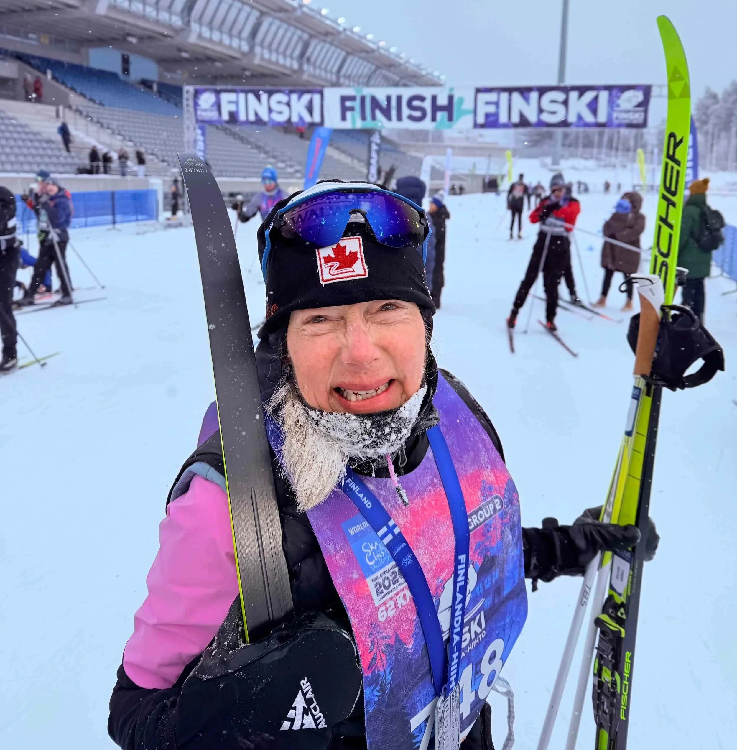 Rhonda Millikin celebrating after successfully completing the Finlandia-Hiihto in snowy winter conditions.