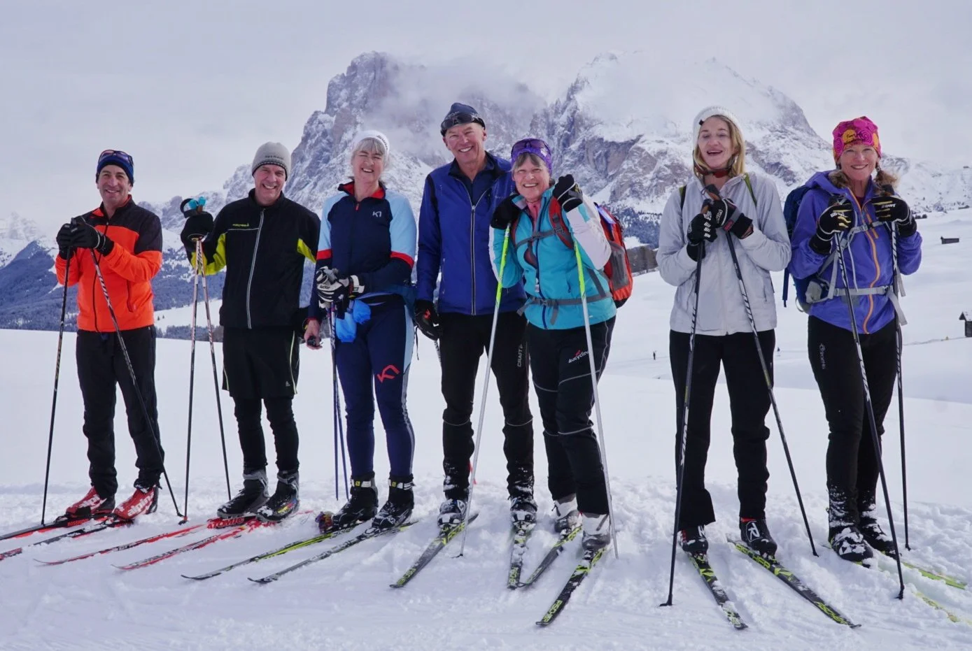 Happy skiers enjoying cross-country ski tours in Italy, smiling on scenic snowy trails