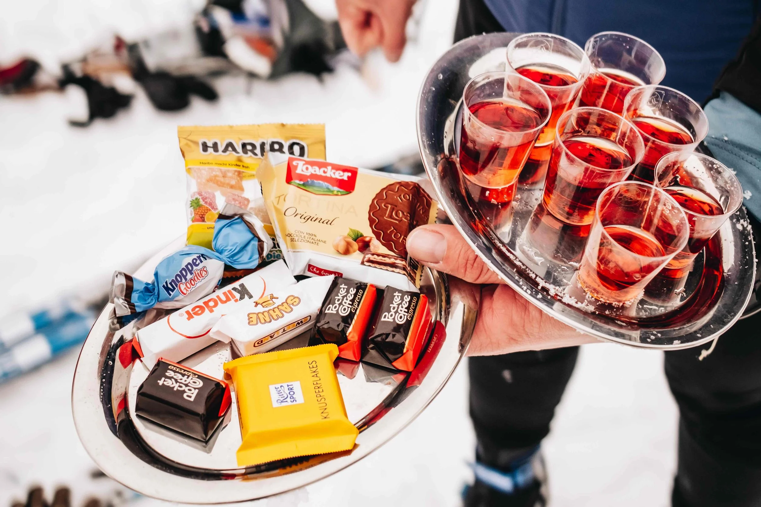 A tray of tasty European chocolates, snacks, and shots served along cross-country ski trails