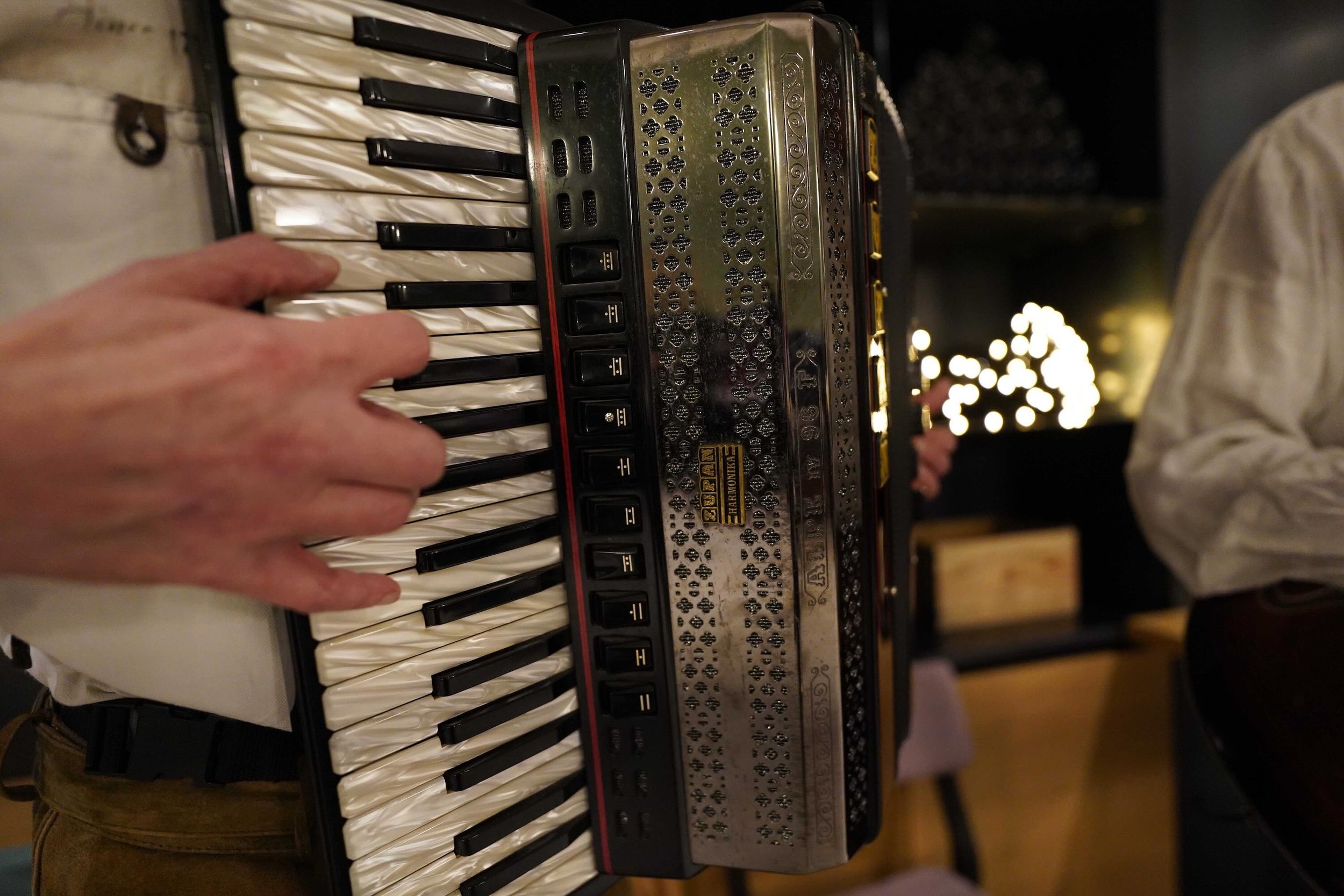 Live accordion music by local musicians enhances a group dinner with Alpine-inspired tunes.