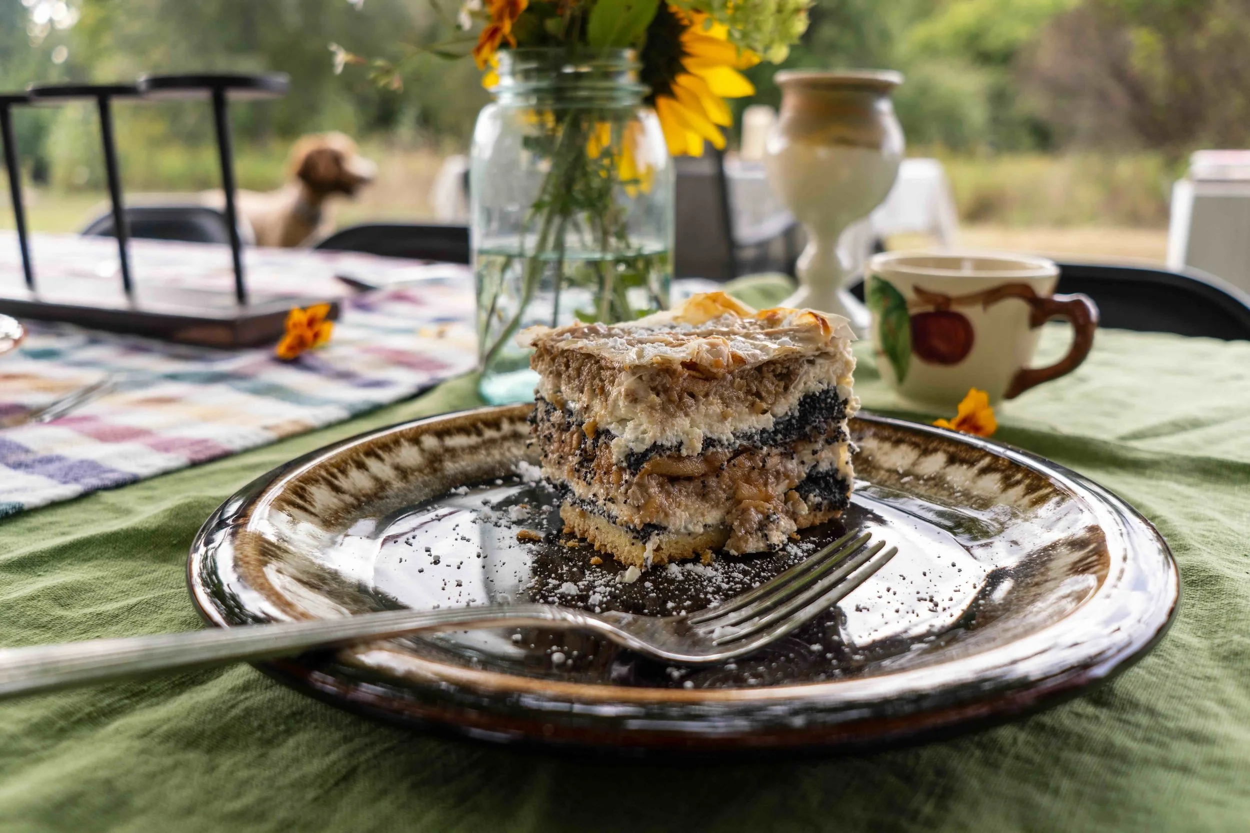 A slice of authentic Slovenian Prekmurska Gibanica pastry enjoyed by travelers during a culinary break on a Lumi Experiences trip in Slovenia