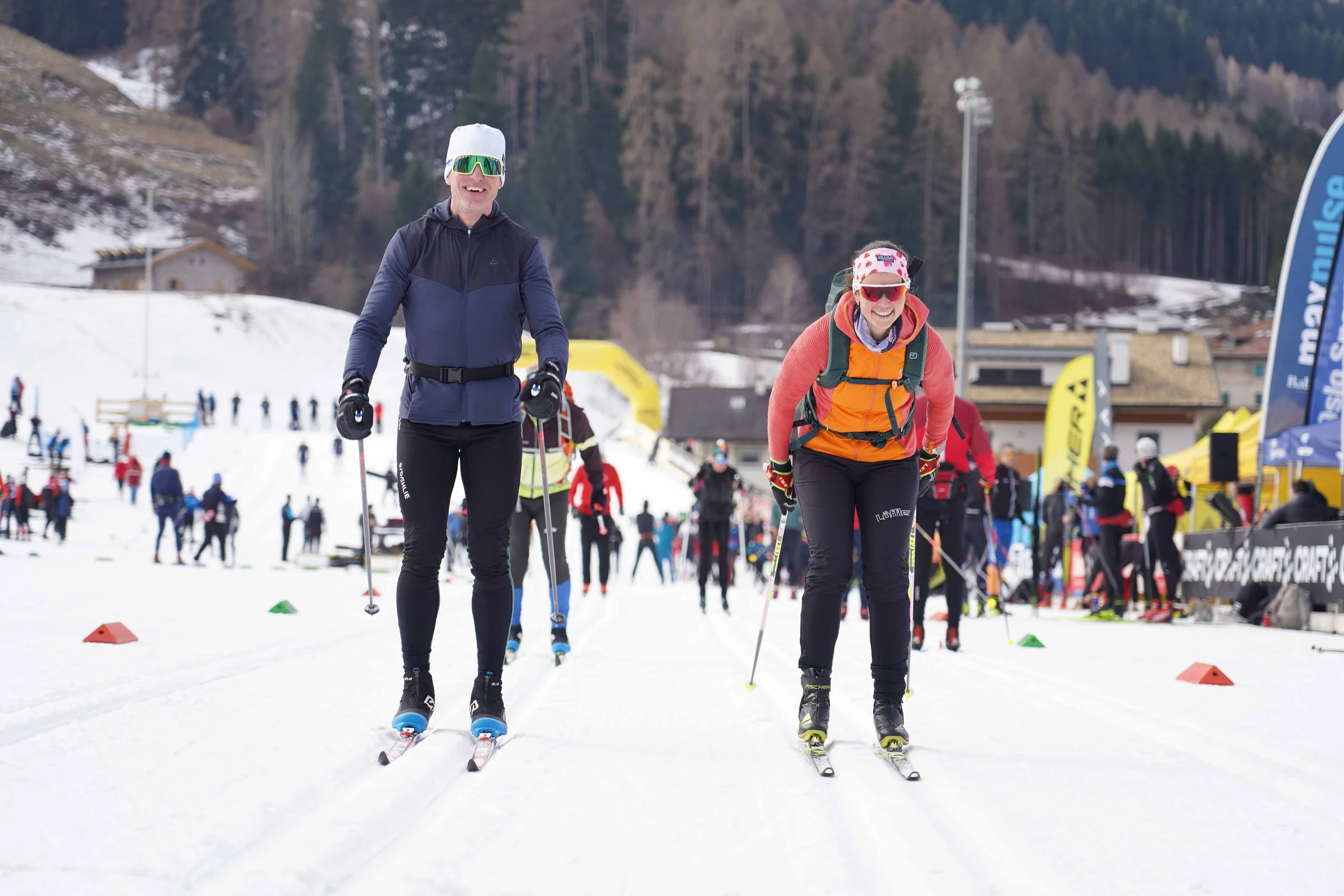 Guests ski alongside Olympian Elisabeth Schicho during a Lumi Experiences Marcialonga ski trip in Italy