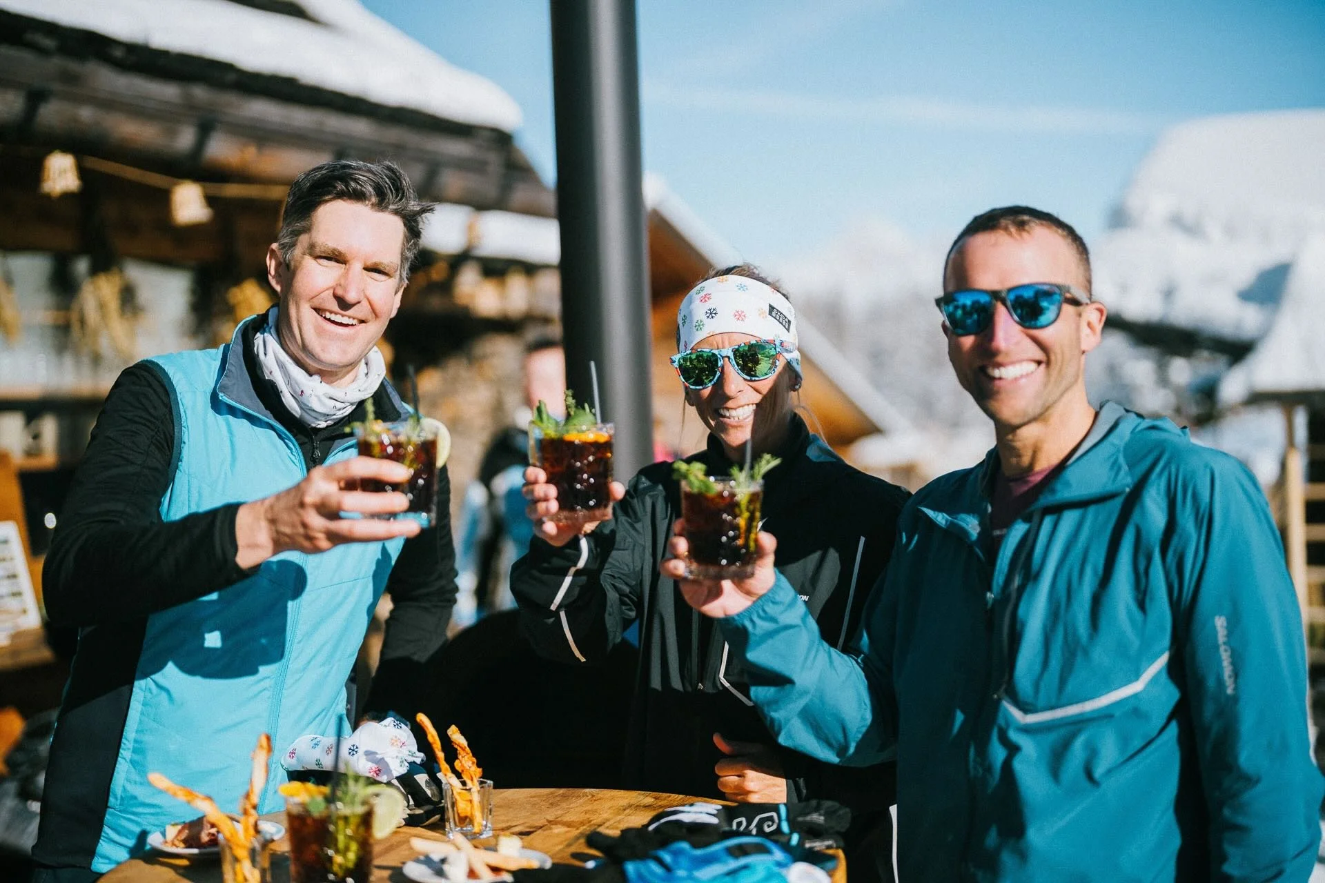 Garrott Kuzzy, Kevin, and Courtney Dauwalter cheering after a day of cross-country skiing on Seiser Alm’s trails