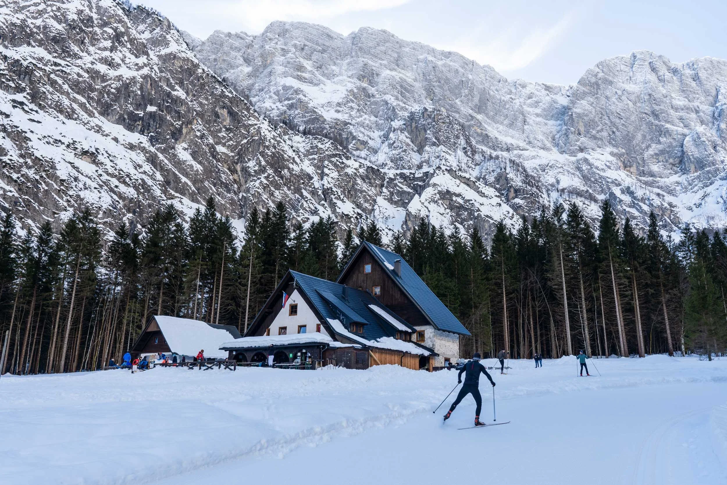 Cross country skiing in winter at Planica leading toward Tamar Hut surrounded by snow-covered mountains
