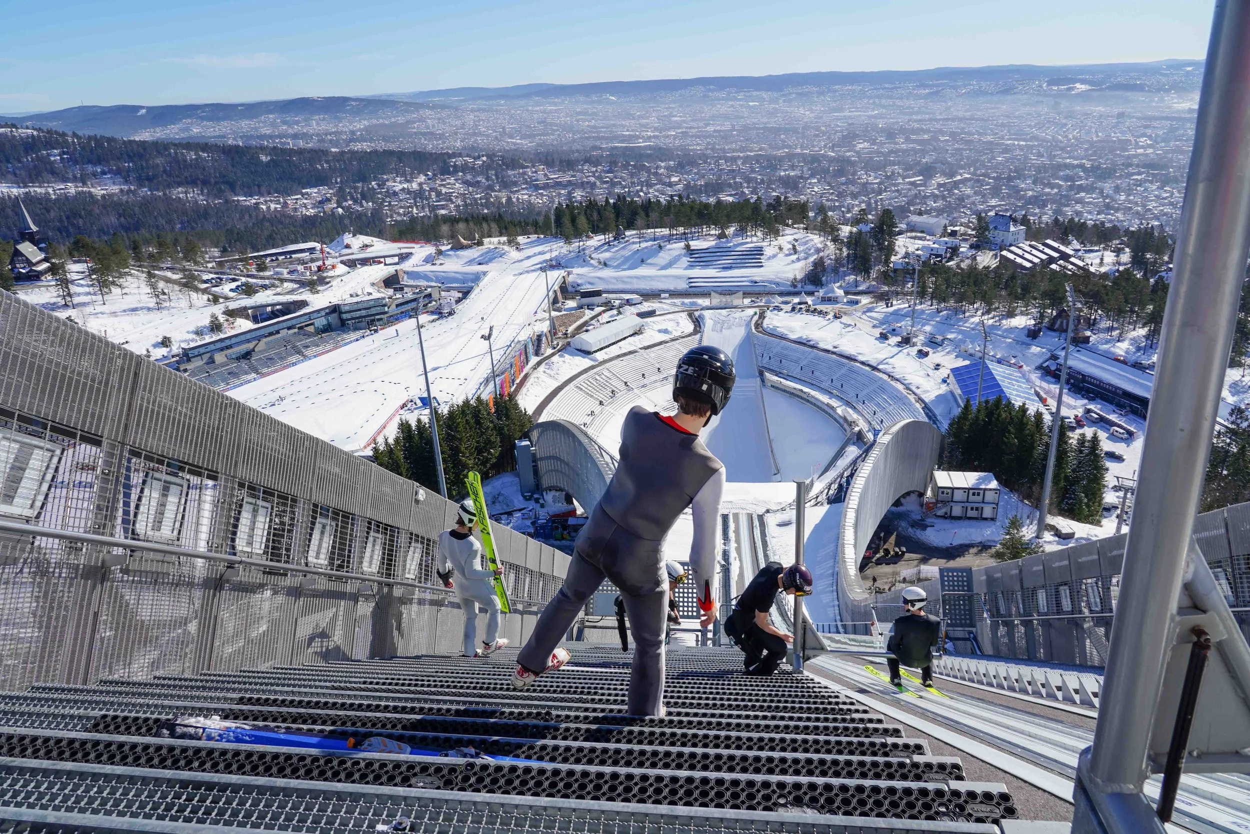 Cross-country skiing at Holmenkollen in Oslo, groomed trails with the iconic landscape in the background.