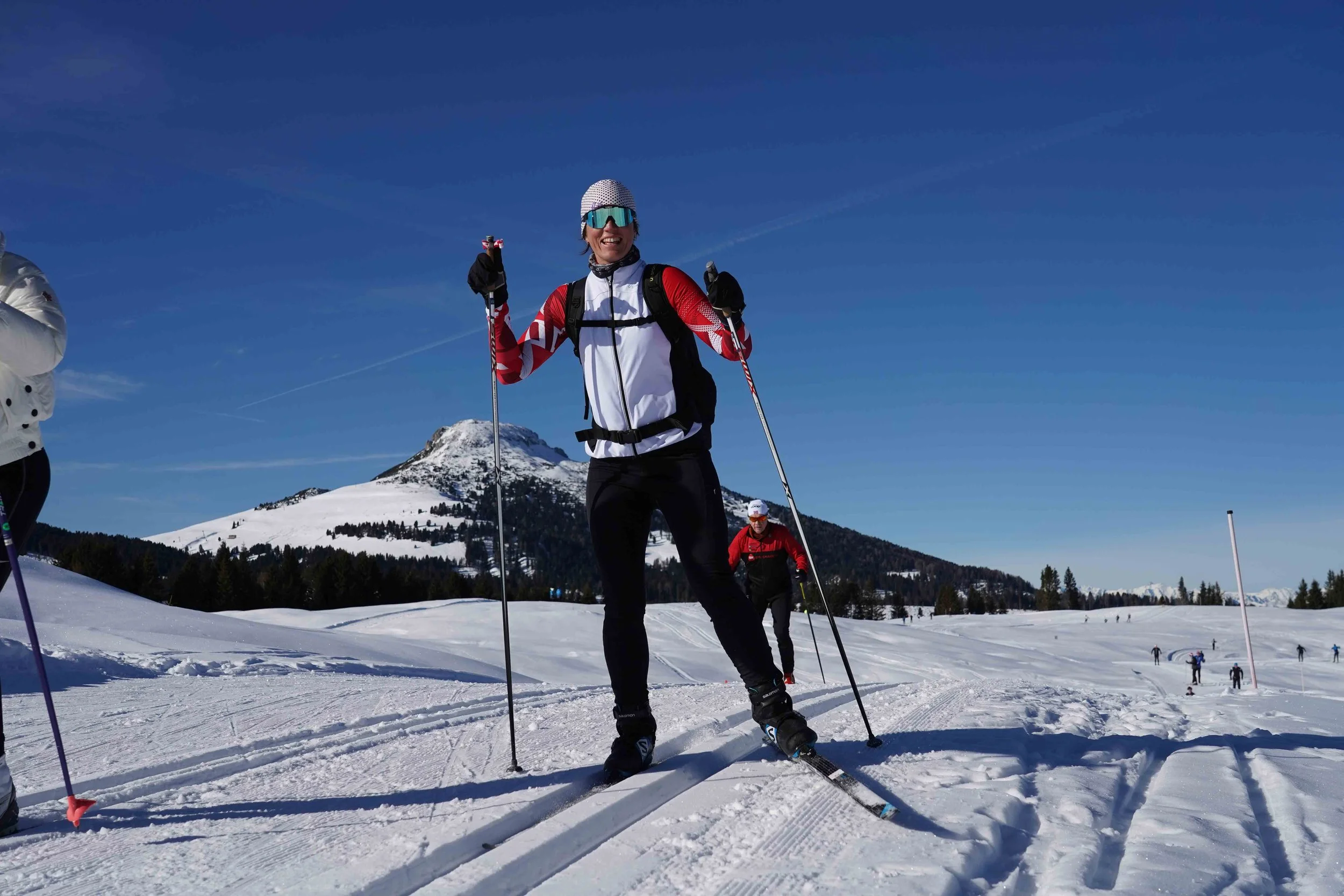 Woman cross-country skiing on a trail in the snowy Dolomites, Italy