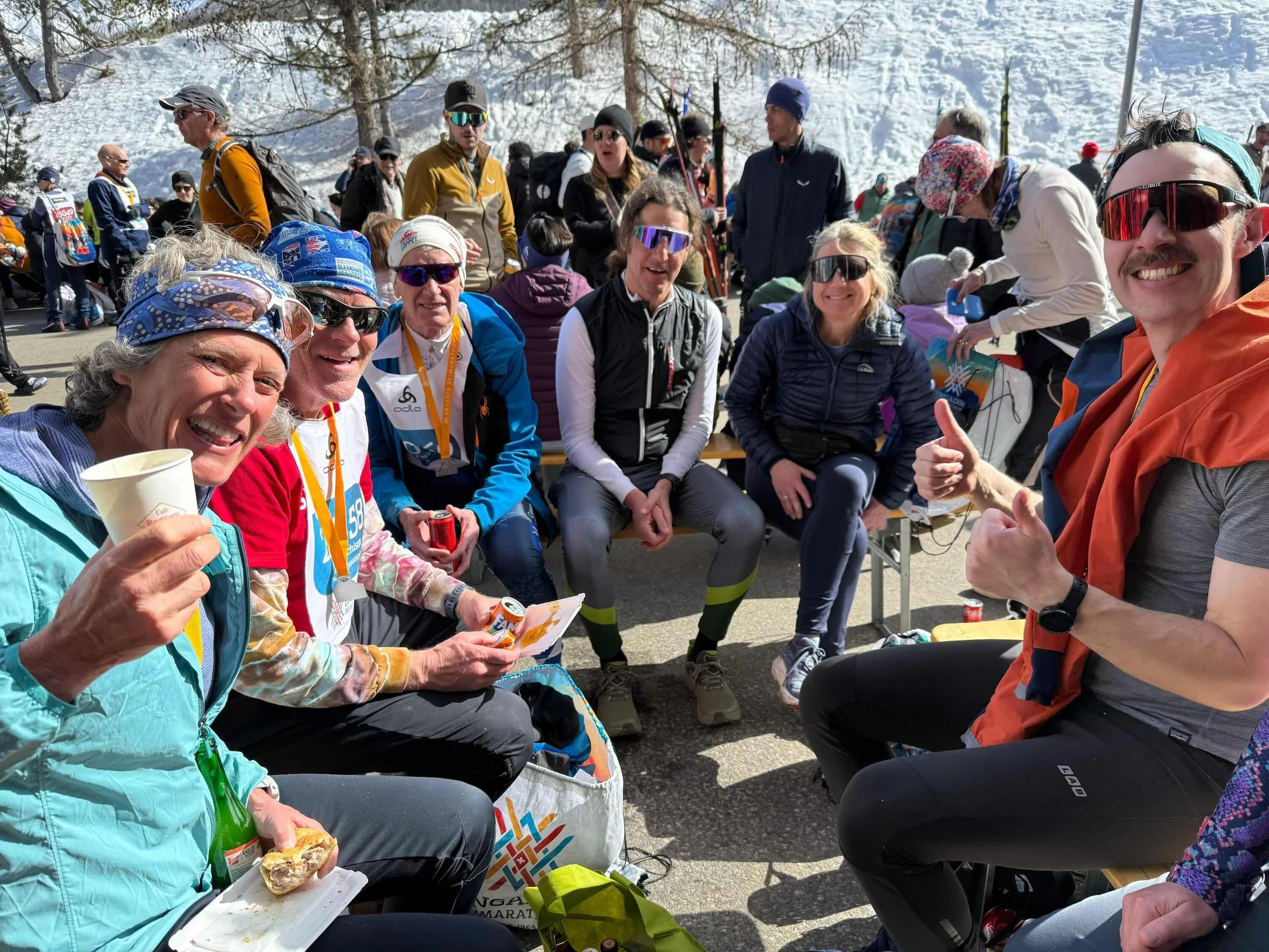 Skiers gathering for snacks after completing the Engadin Worldloppet cross-country marathon