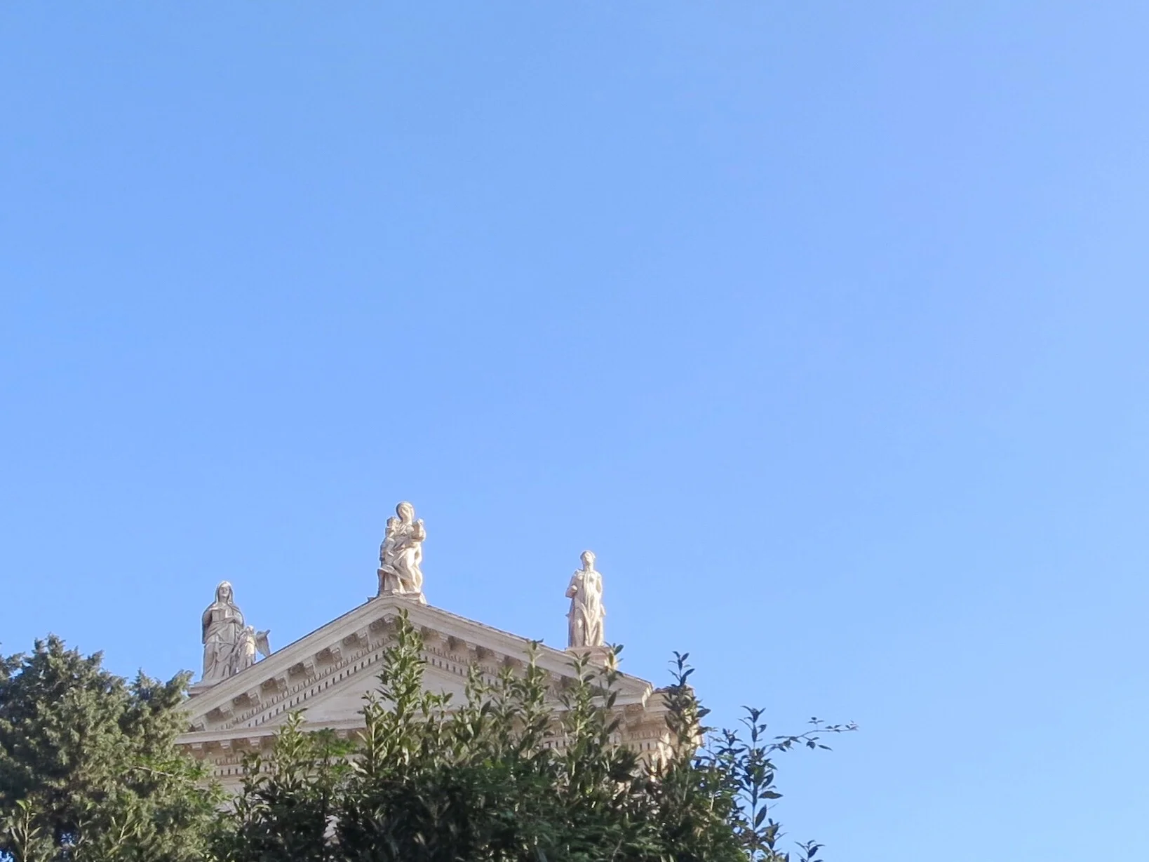 Statues atop a temple in the Roman Forum in Rome, Italy.
