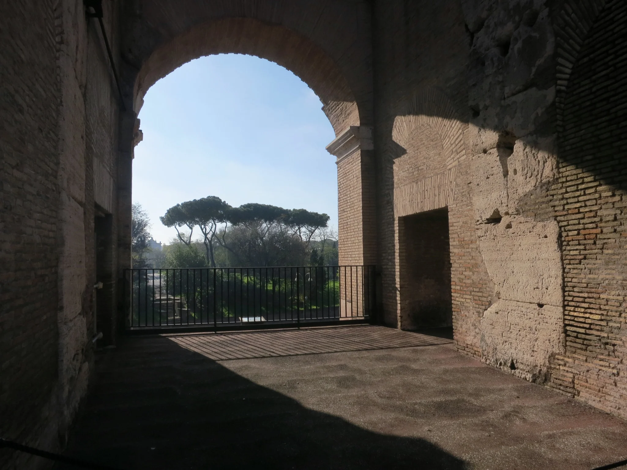 Arches frame beautiful views of the city throughout the Colosseum in Rome, Italy.