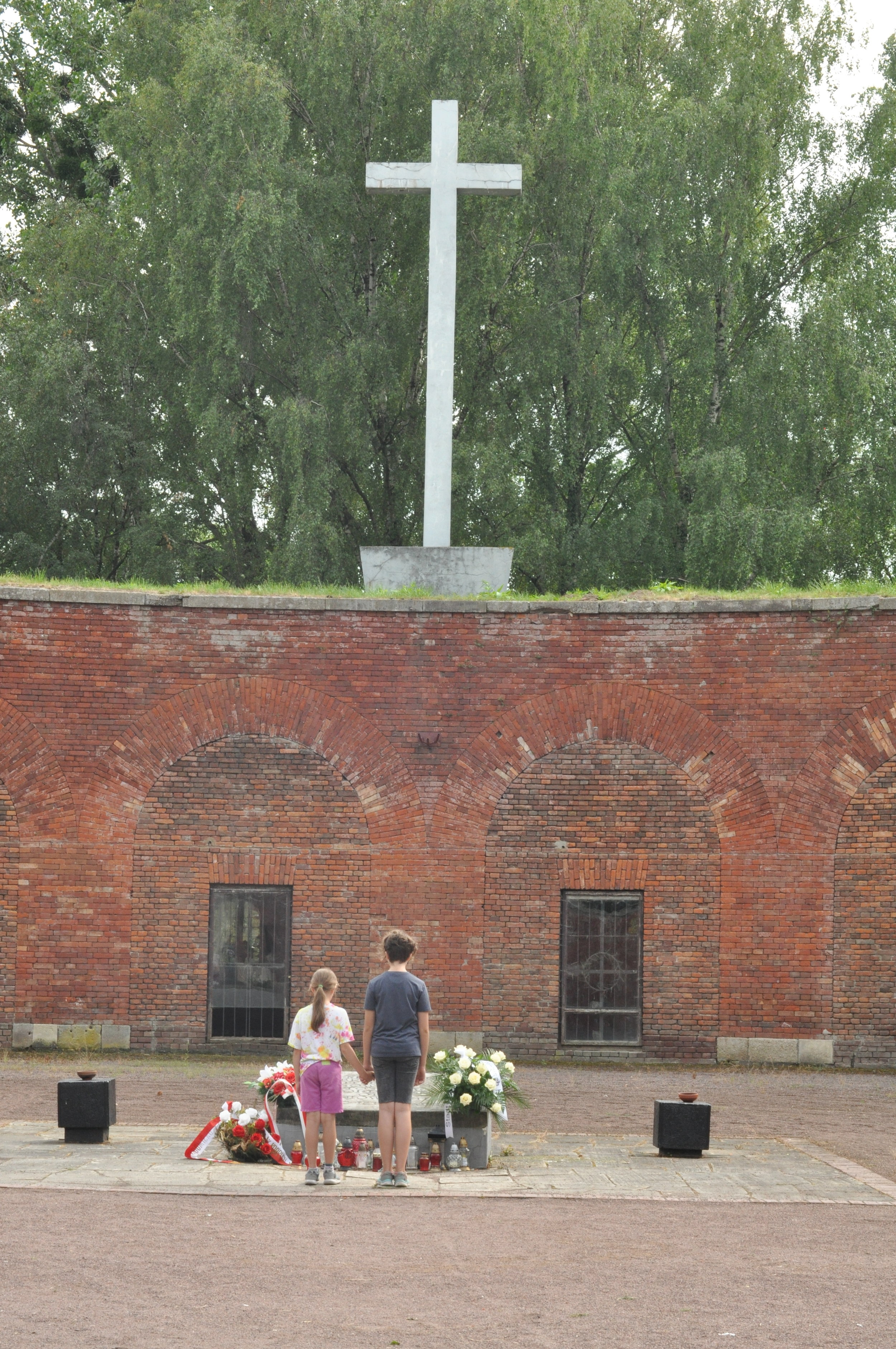 Two children pay their respects at the Rotunda in Zamosc, Poland