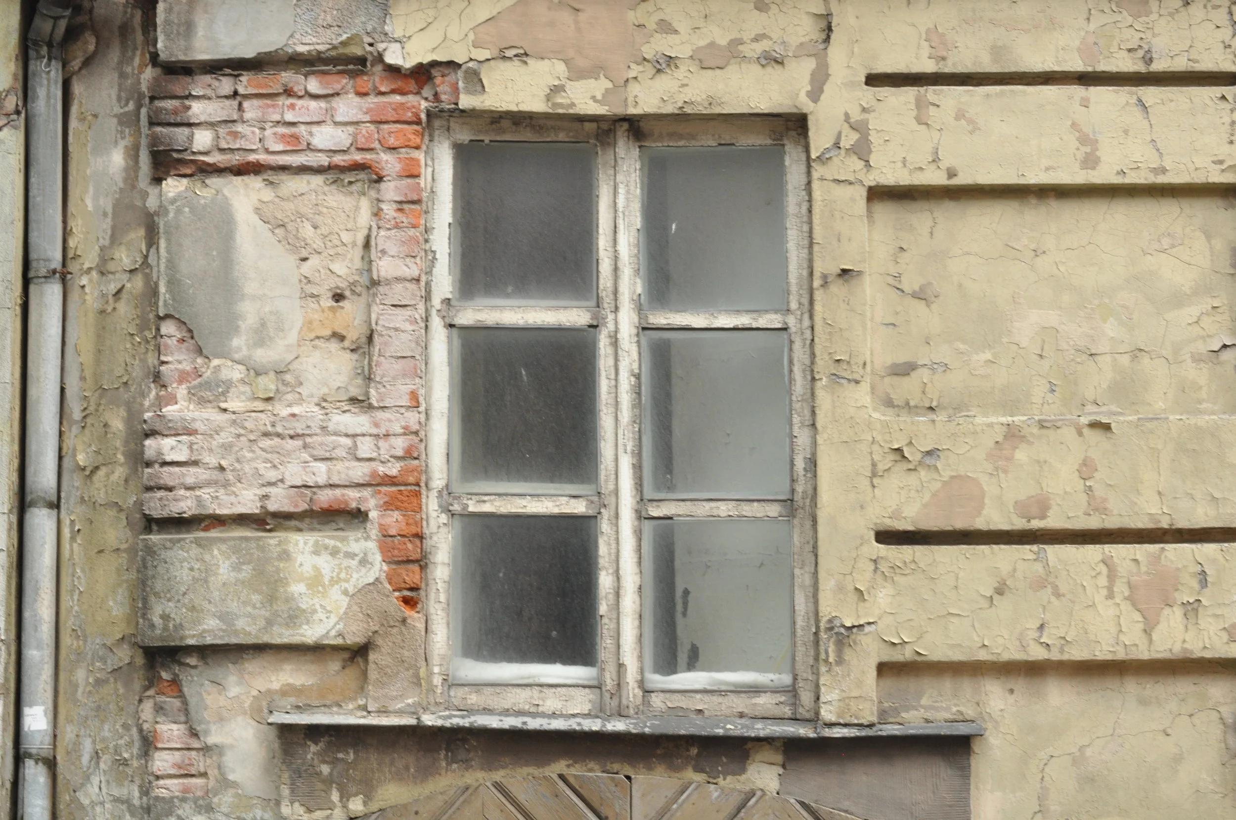 Crumbling brick and window in Riga, Latvia 