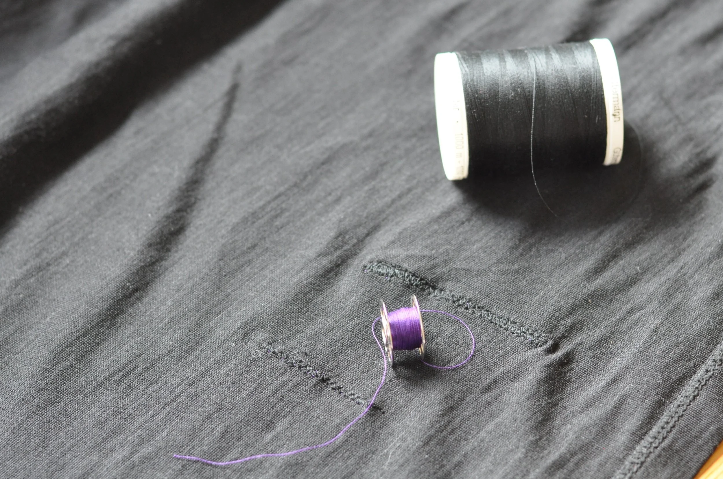 Mends made by sewing machine on black t-shirt