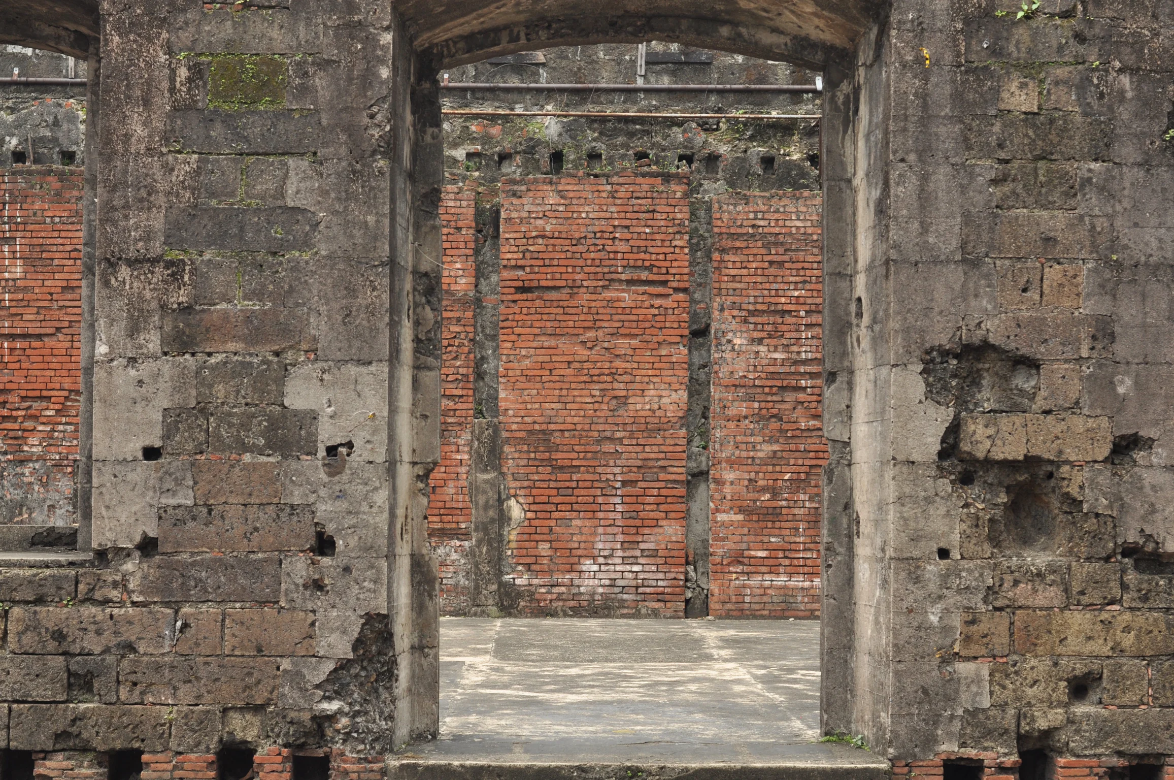 Stone wall leading into remains of buildings in Fort Santiago Intramuros, Manila, Philippines