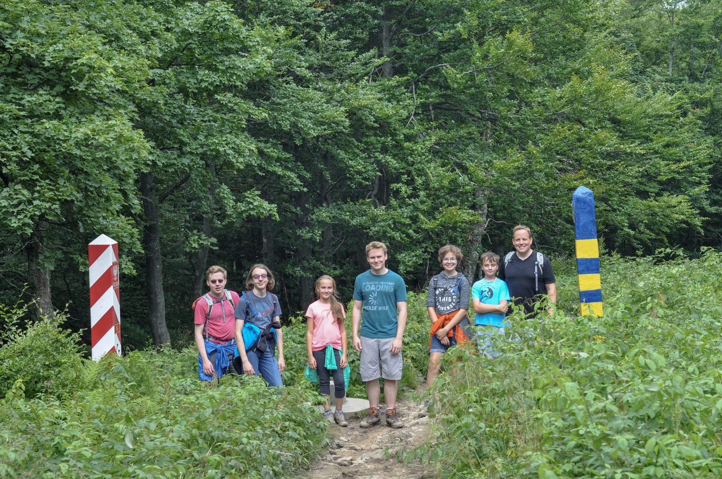 Hikers between the Polish and Ukrainian border markers on the Tri-border Hike in the Bieszcady Mountains