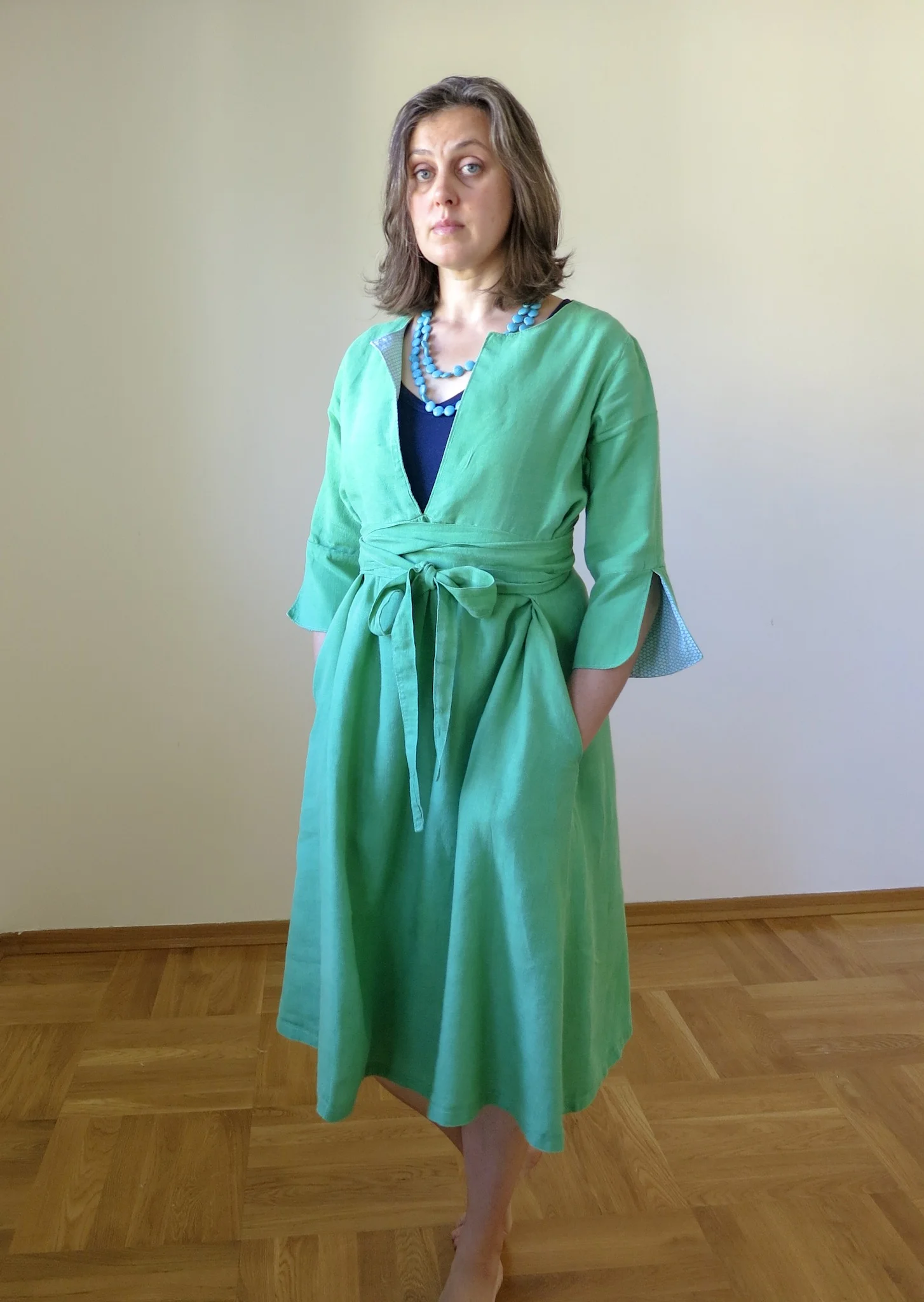Schoolhouse Tunic pattern turned into a dress with ties and pockets in green linen