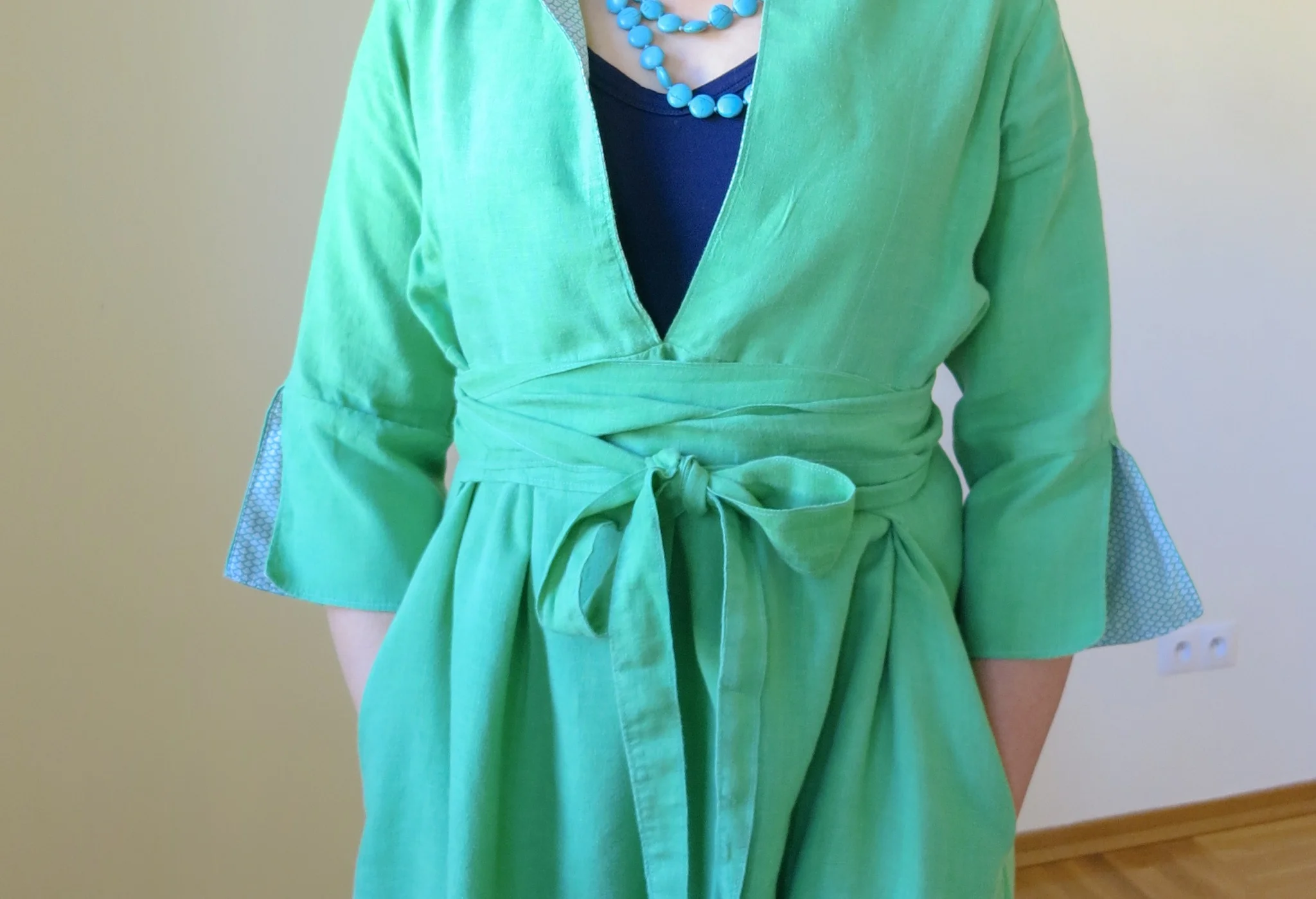 Tie detail on a green linen Schoolhouse Tunic dress