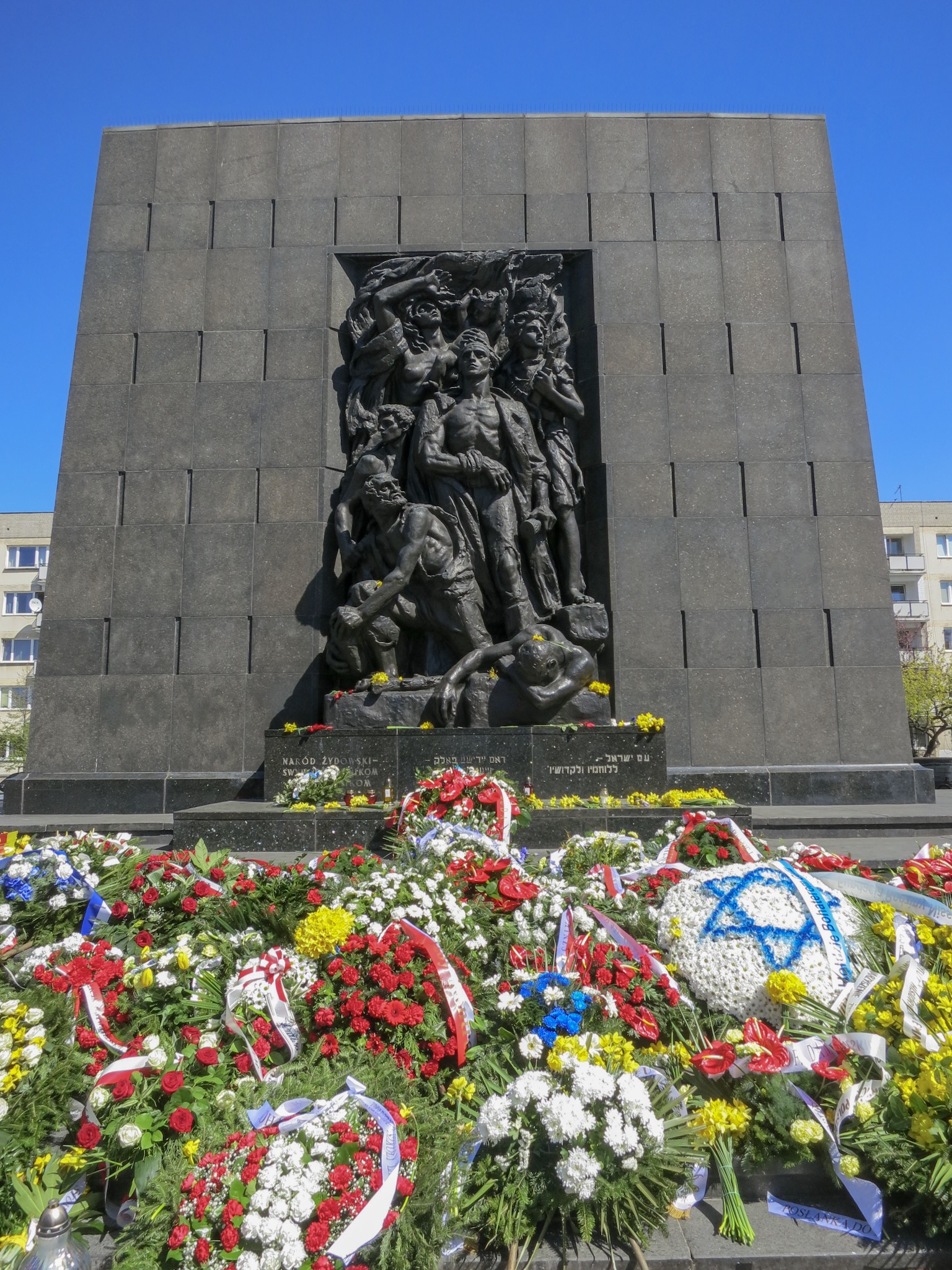 Heroes of the Ghetto Monument covered in wreaths and flowers in commemoration of the 76th Anniversary of the Warsaw Ghetto Uprising