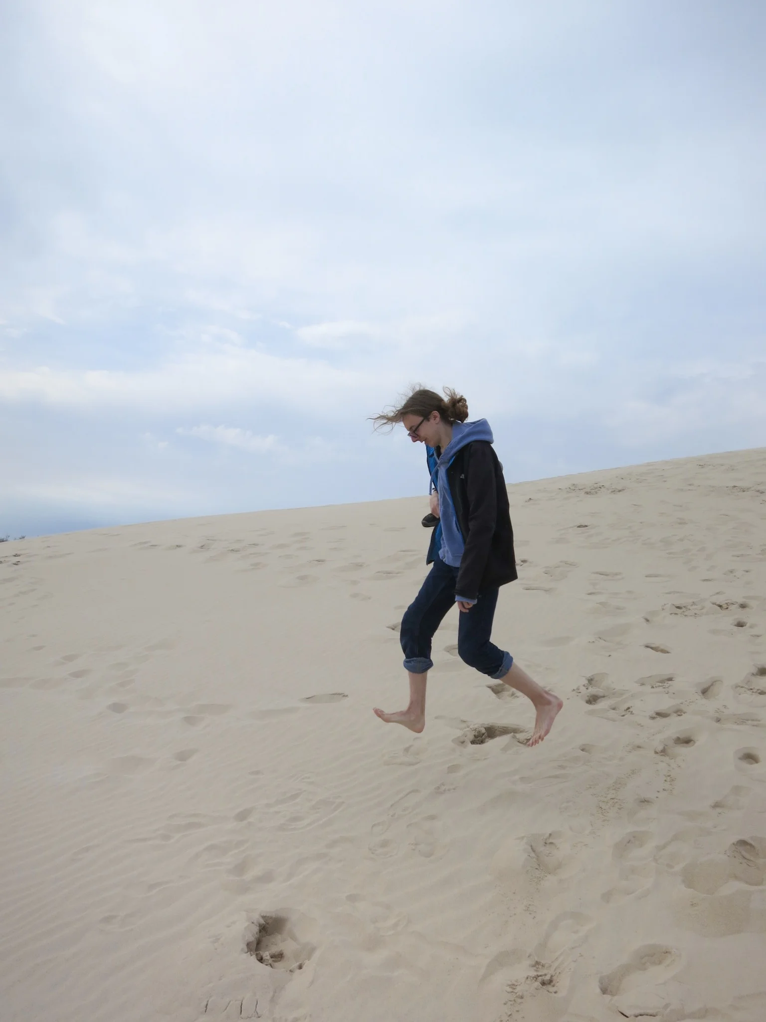 Jumping above the sands on the Łackca Sand Dune In Słowiński National Park