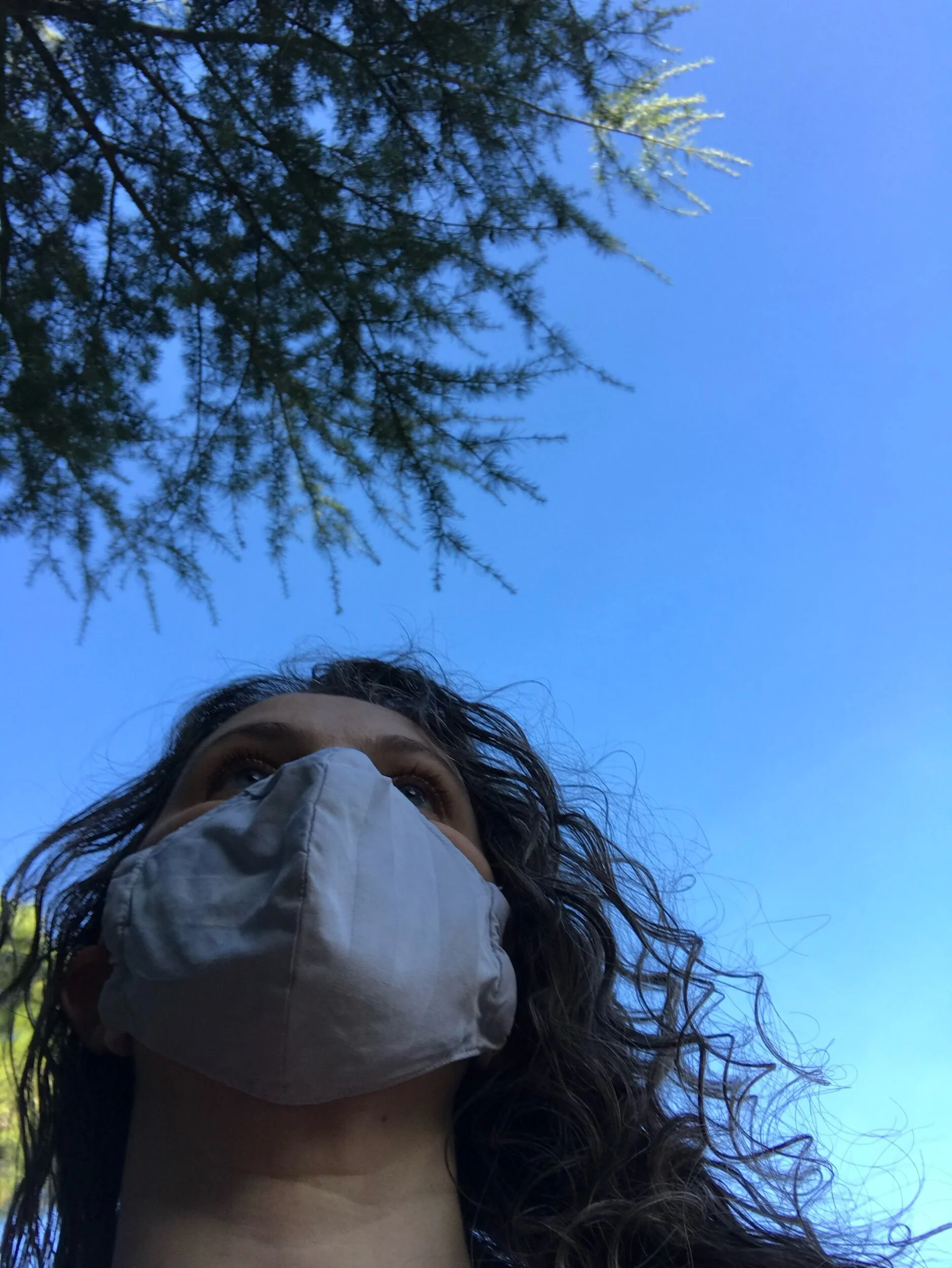 Woman wearing a mask, as shot from below