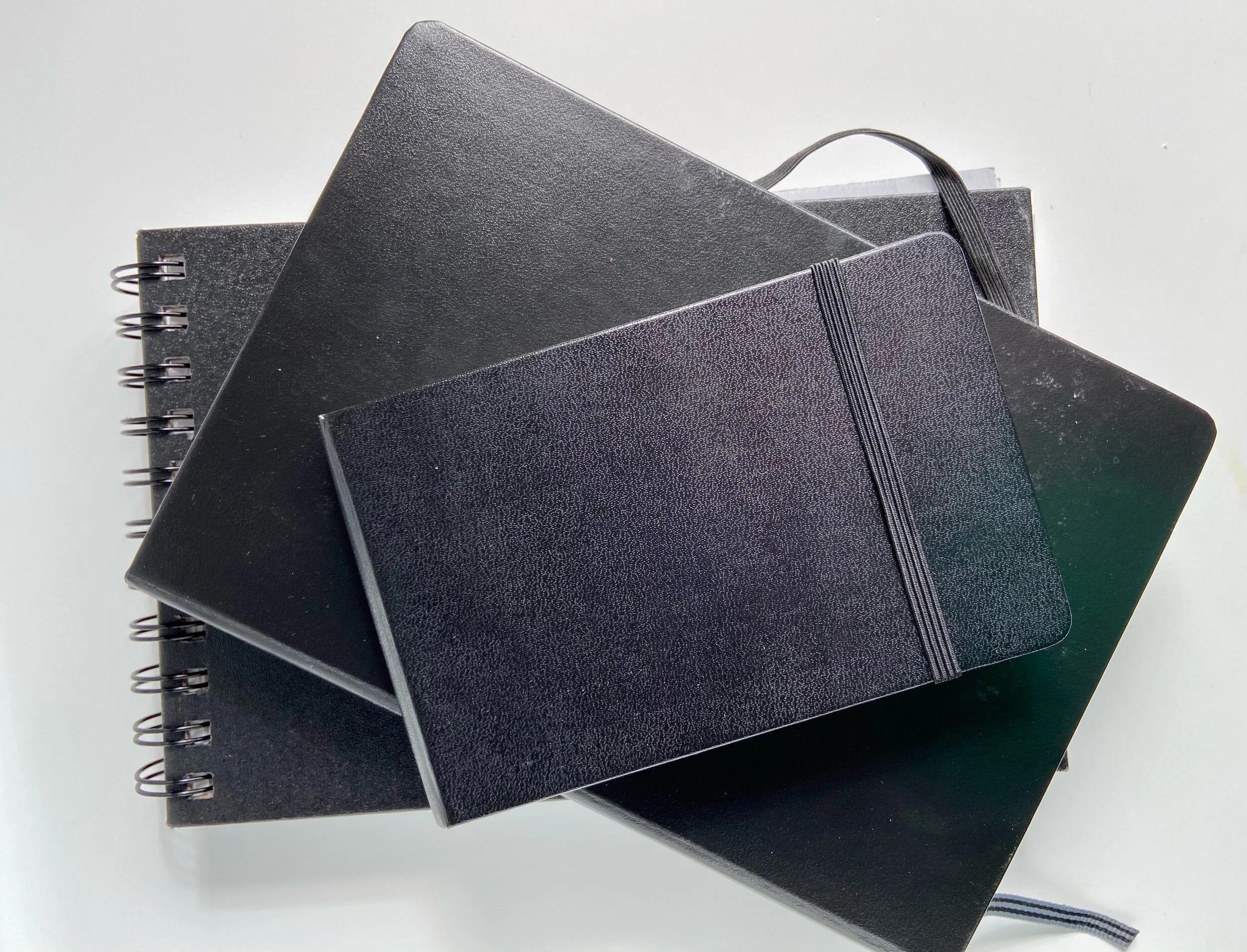 Pile of three black covered books