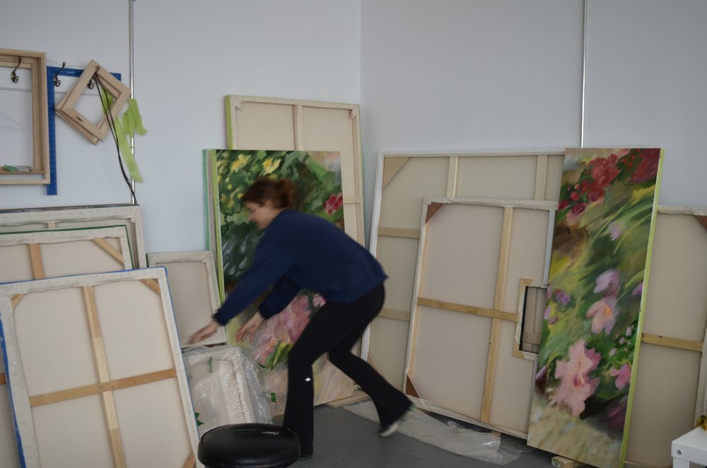 Béatrice Côté showcasing canvases in her studio