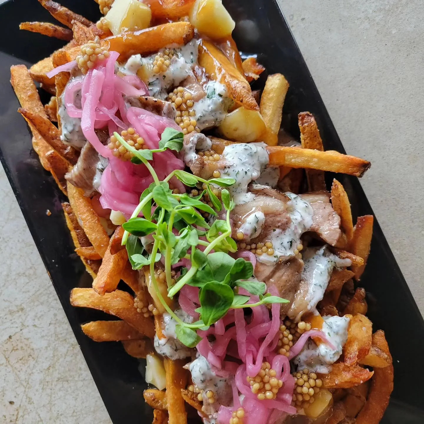 Lamb Poutine is back for October! Created by chef Jason, it features braised lamb, mint yogurt sauce, pickled red onion, and mustard seeds. 

Proceeds from sales are going to Strangers No Longer Detroit, a non-profit directly supporting families and 