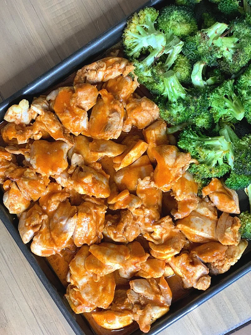 Easy buffalo chicken sheet pan dinner with a sugar free sauce. High protein, low carb, and perfect for meal prep or quick healthy meals.